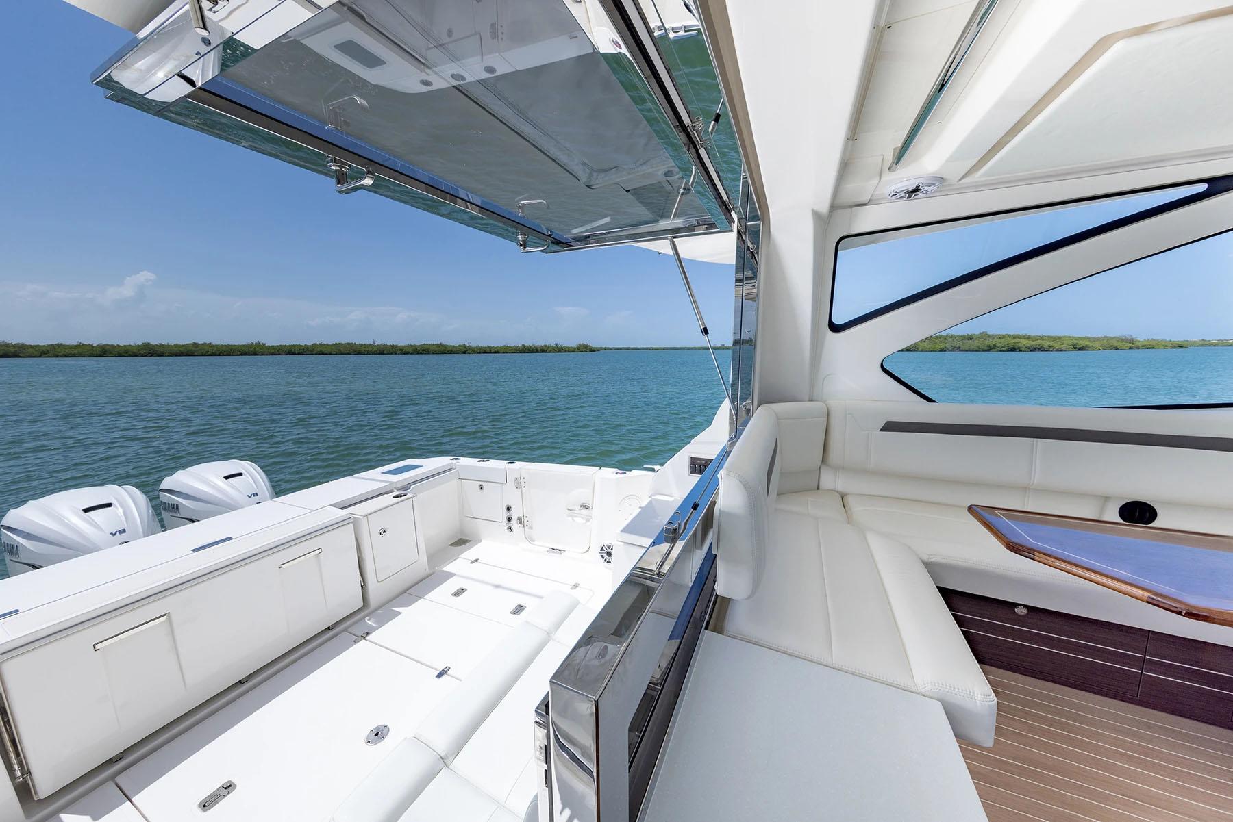 Manufacturer Provided Image: 2025 Pursuit OS 445 Offshore yacht interior with ocean view, featuring luxurious seating and modern design.