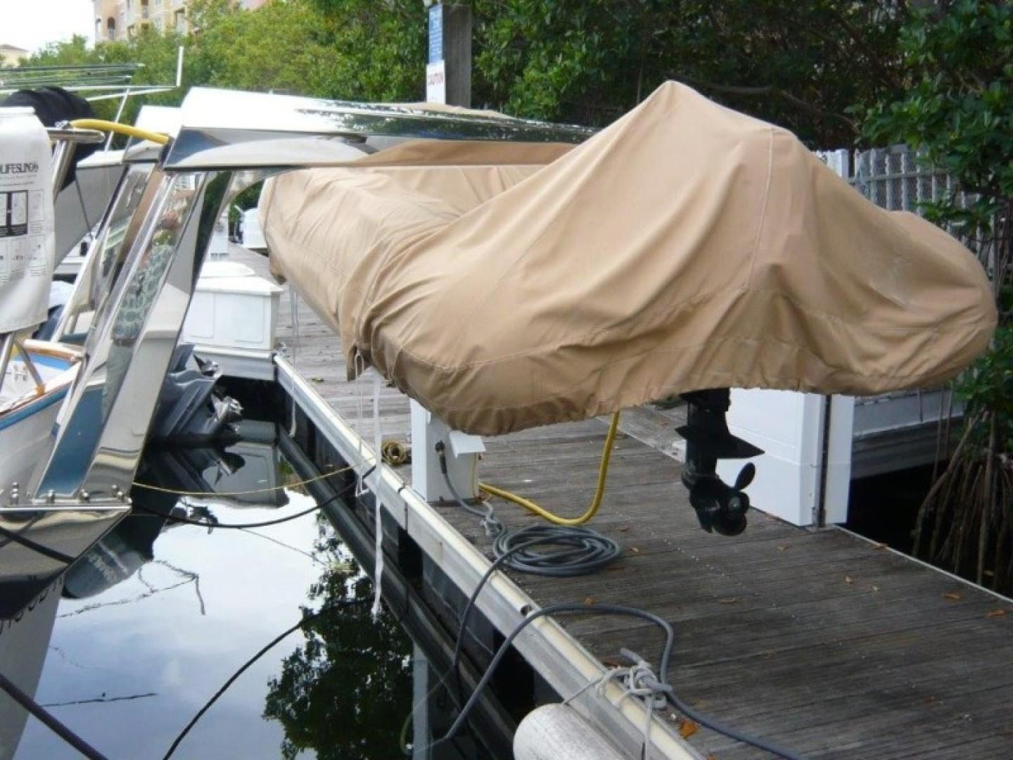 Covered boat docked at marina, Cheoy Lee Sloop, 1990 model.