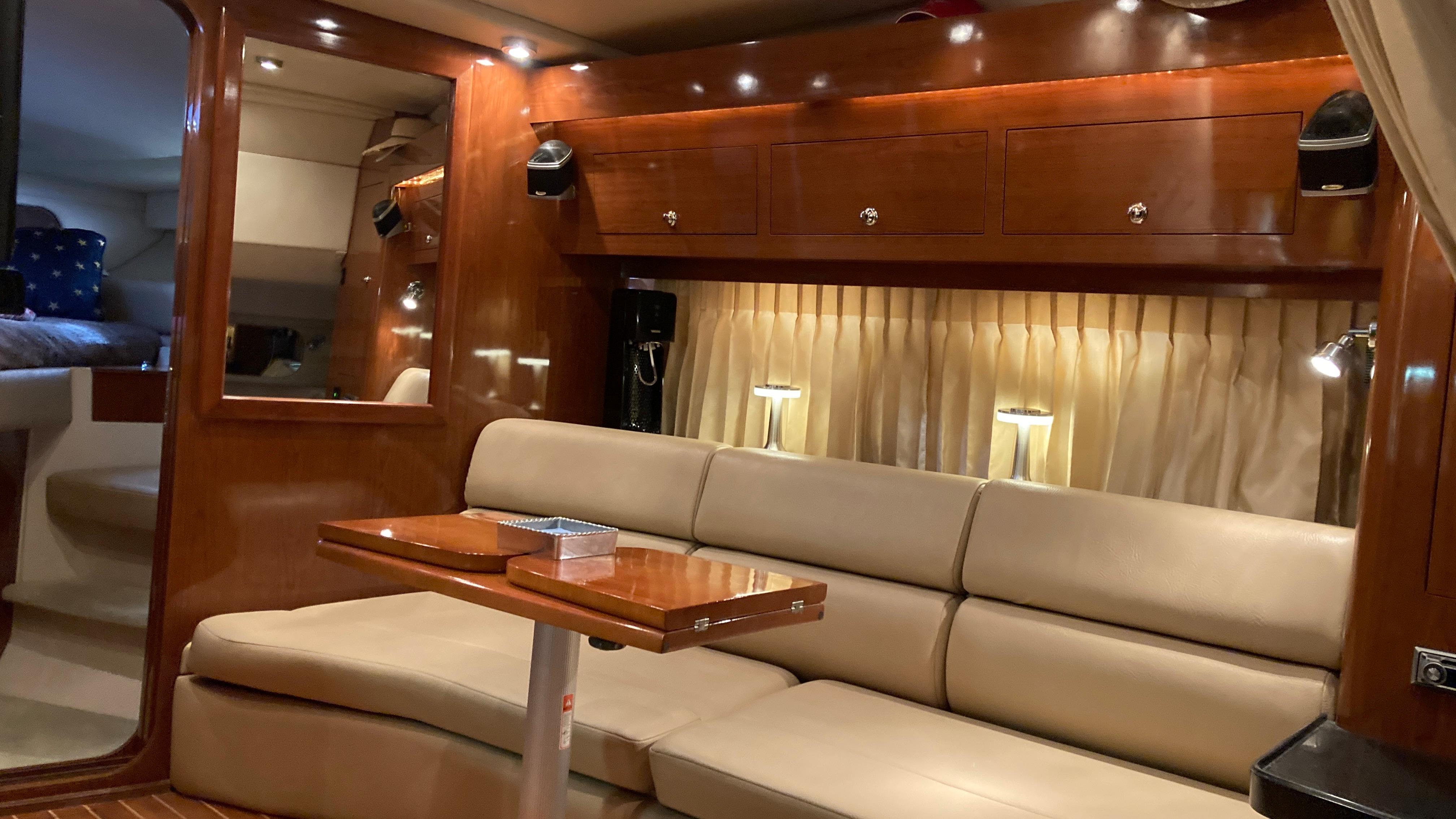Luxurious interior of a 2007 Regal 3760 Commodore yacht with elegant seating and wood finishes.