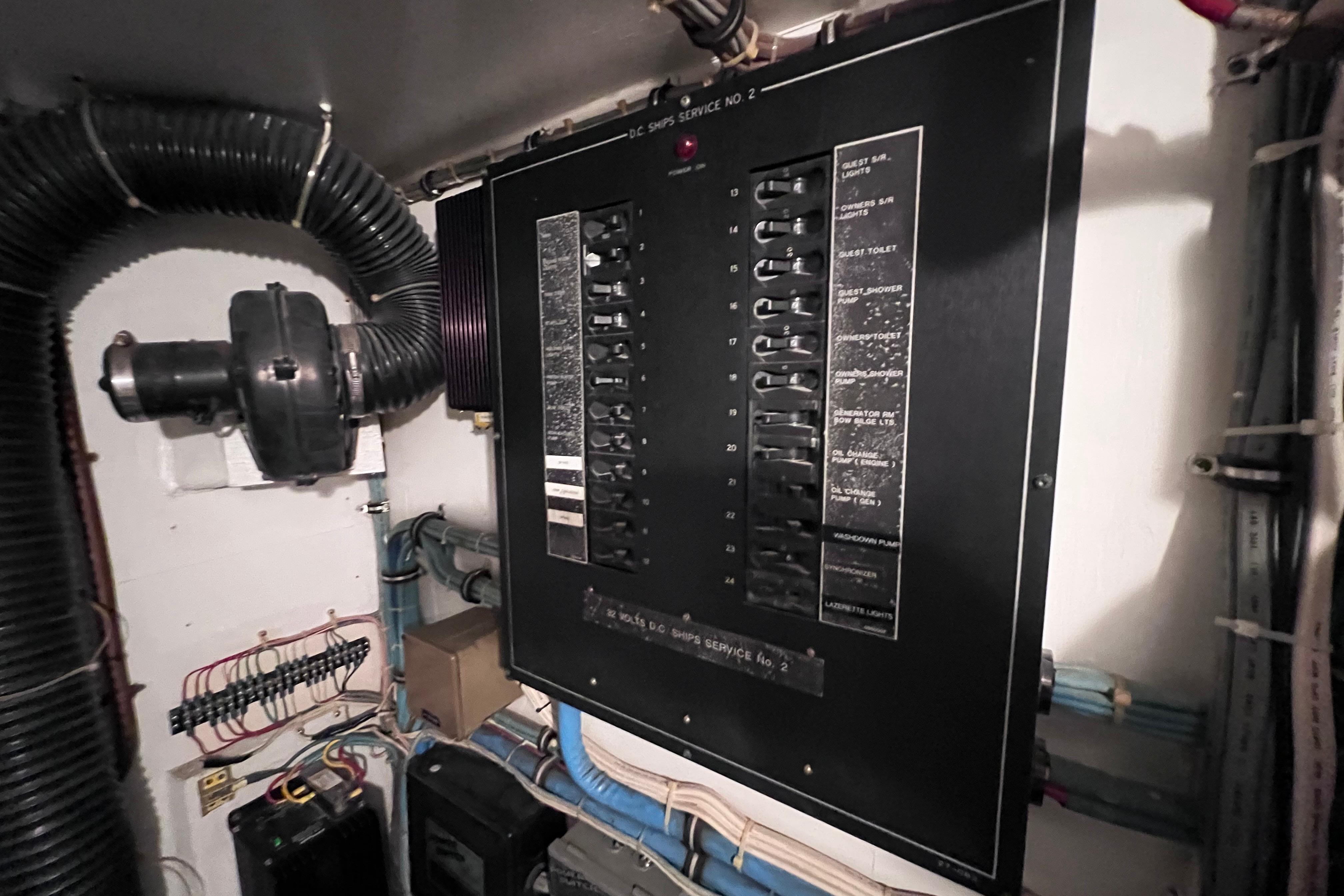 Electrical panel in 1987 Hatteras 70 Cockpit Motor Yacht engine room, showcasing wiring and components.