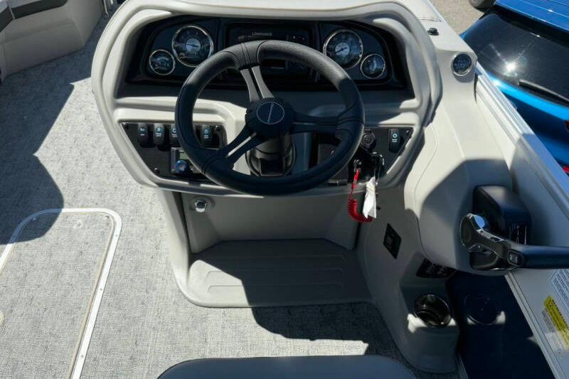 Steering console of 2026 Berkshire LE 24' Ultra Lounger boat, featuring modern controls and gauges.