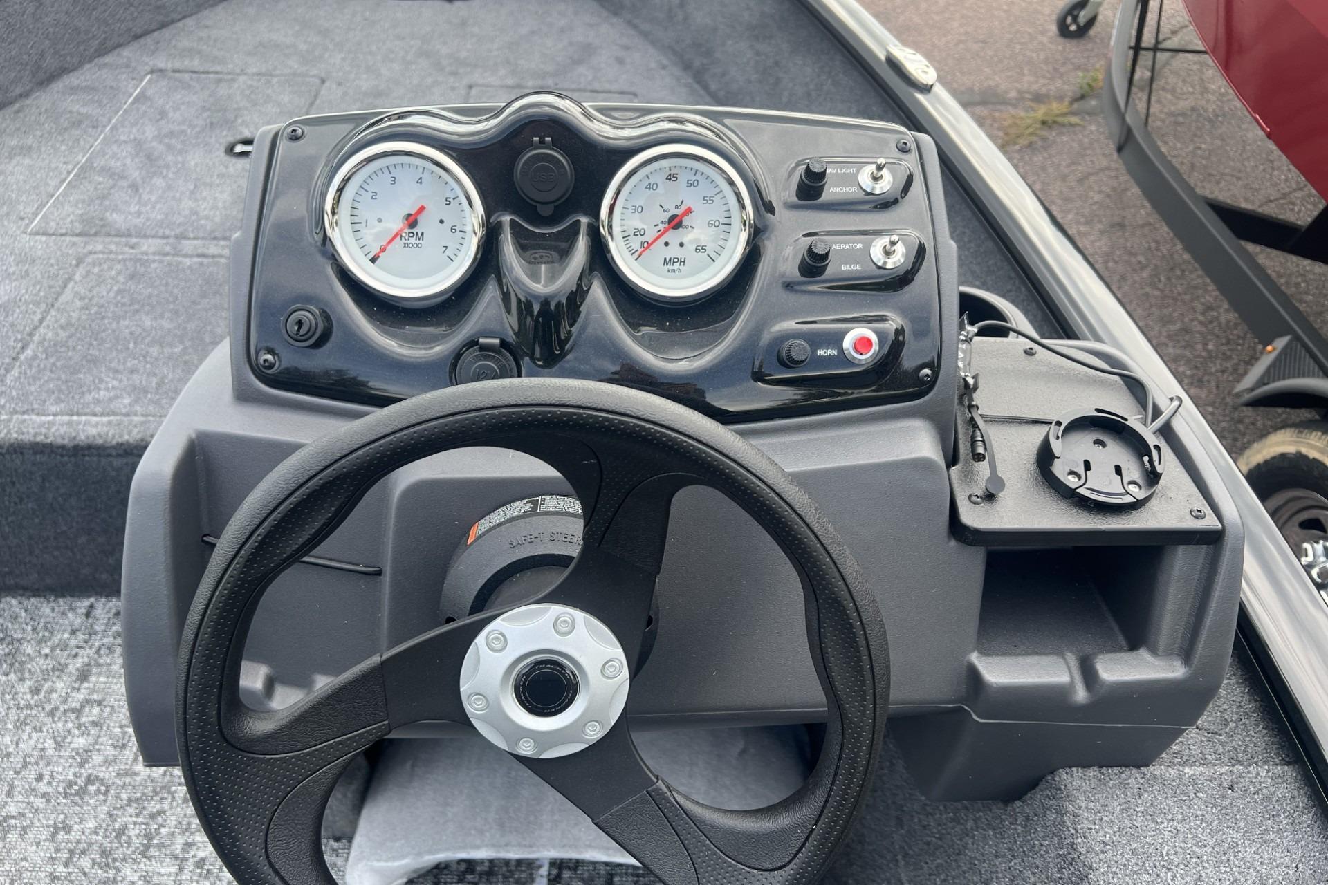 Steering console of 2026 Tracker Super Guide V-16 SC boat with gauges and controls.
