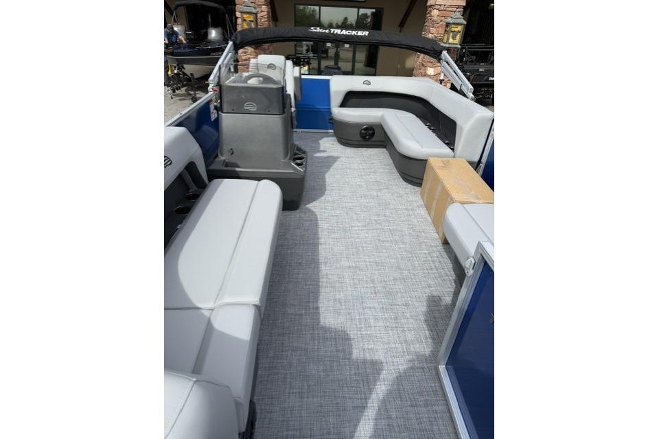 2026 Sun Tracker Party Barge 16 DLX interior with gray seating and spacious layout.