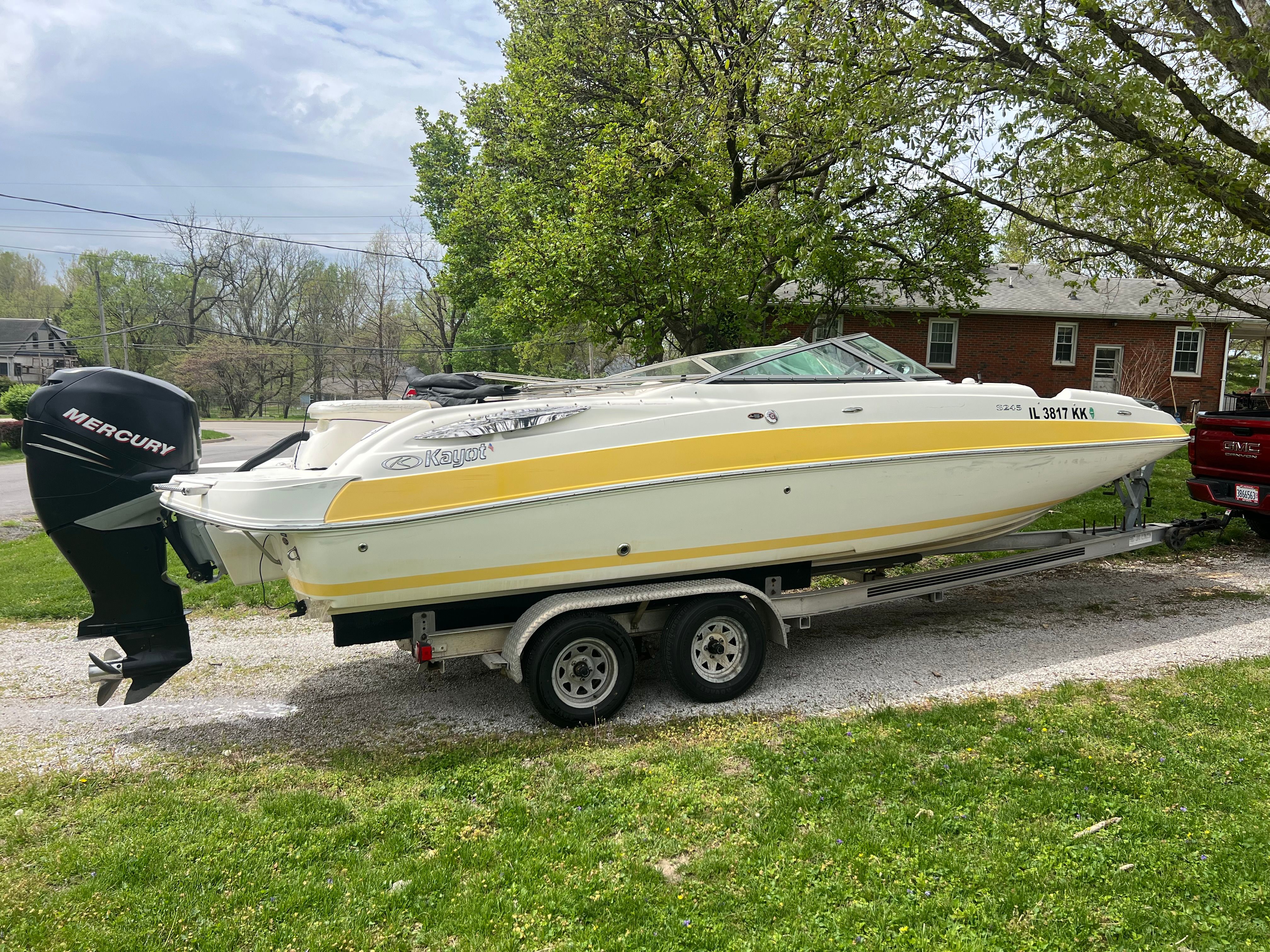 2007 Harris-Kayot S245 boat parked on trailer outdoors.