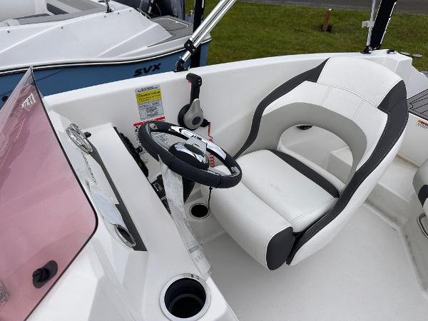 2024 Starcraft 171 SVX boat cockpit with steering wheel and comfortable seating.