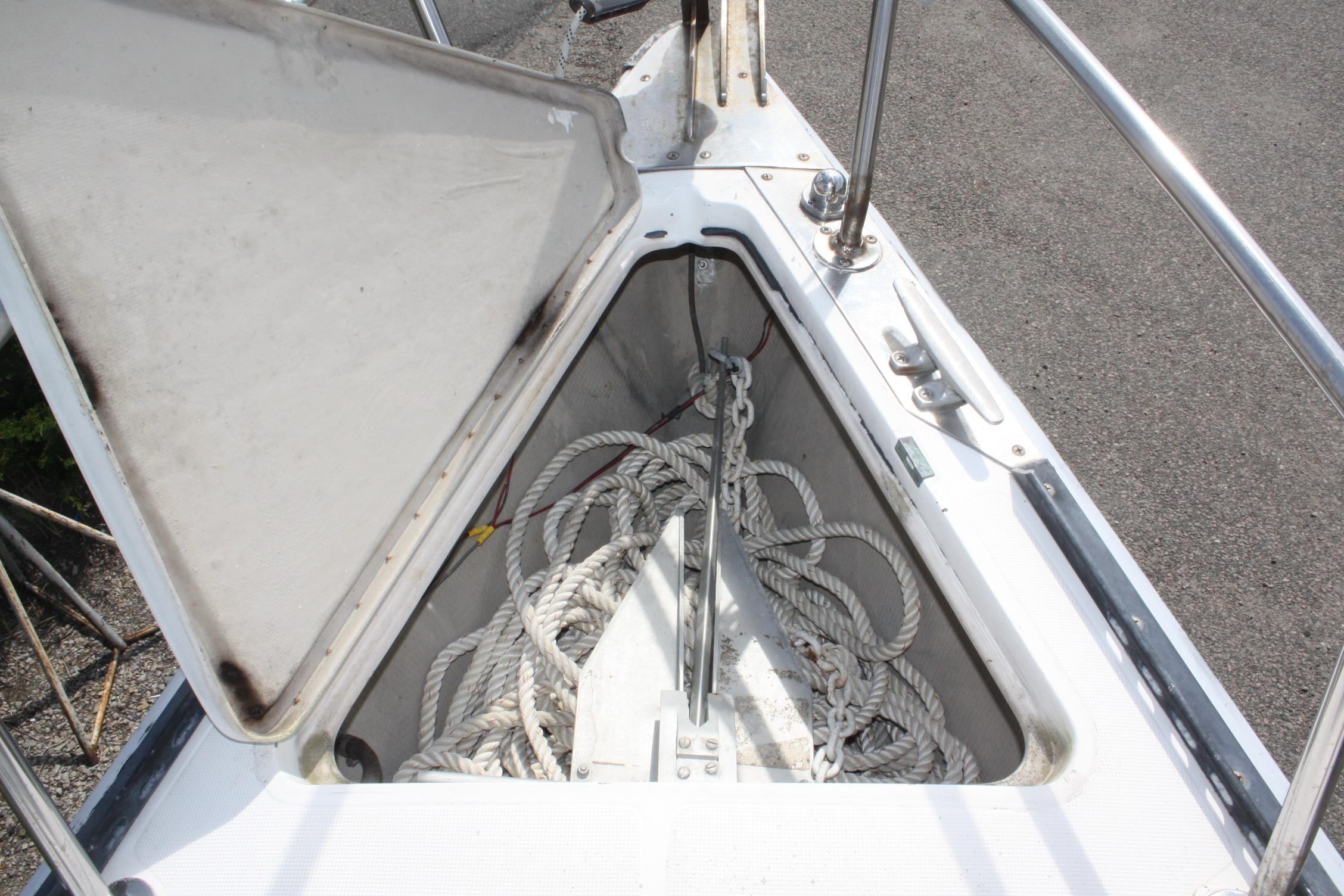 Anchor locker of 1981 S2 9.2A sailboat with coiled ropes inside.