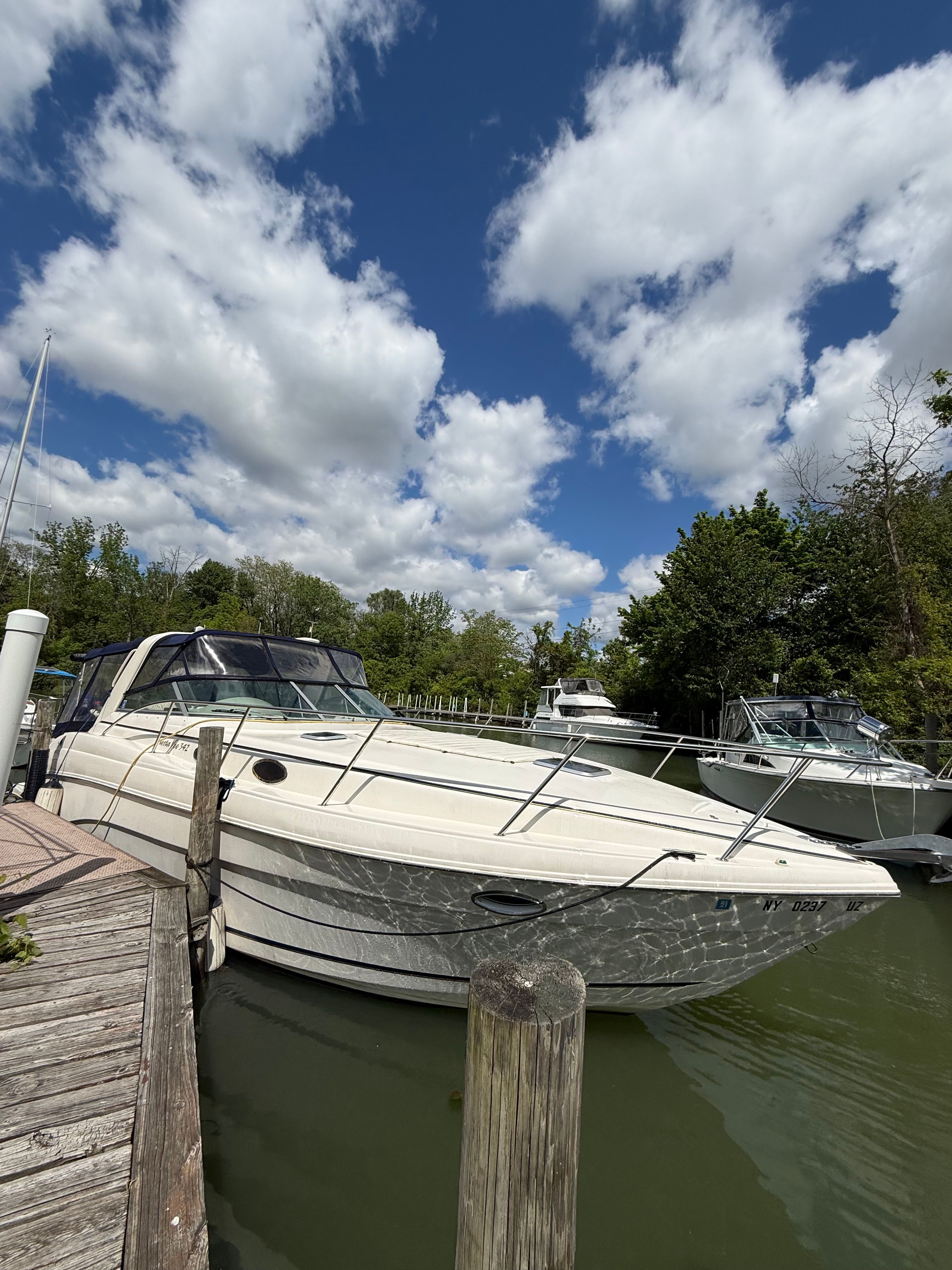 2002 Rinker Fiesta Vee 342 docked under blue sky.