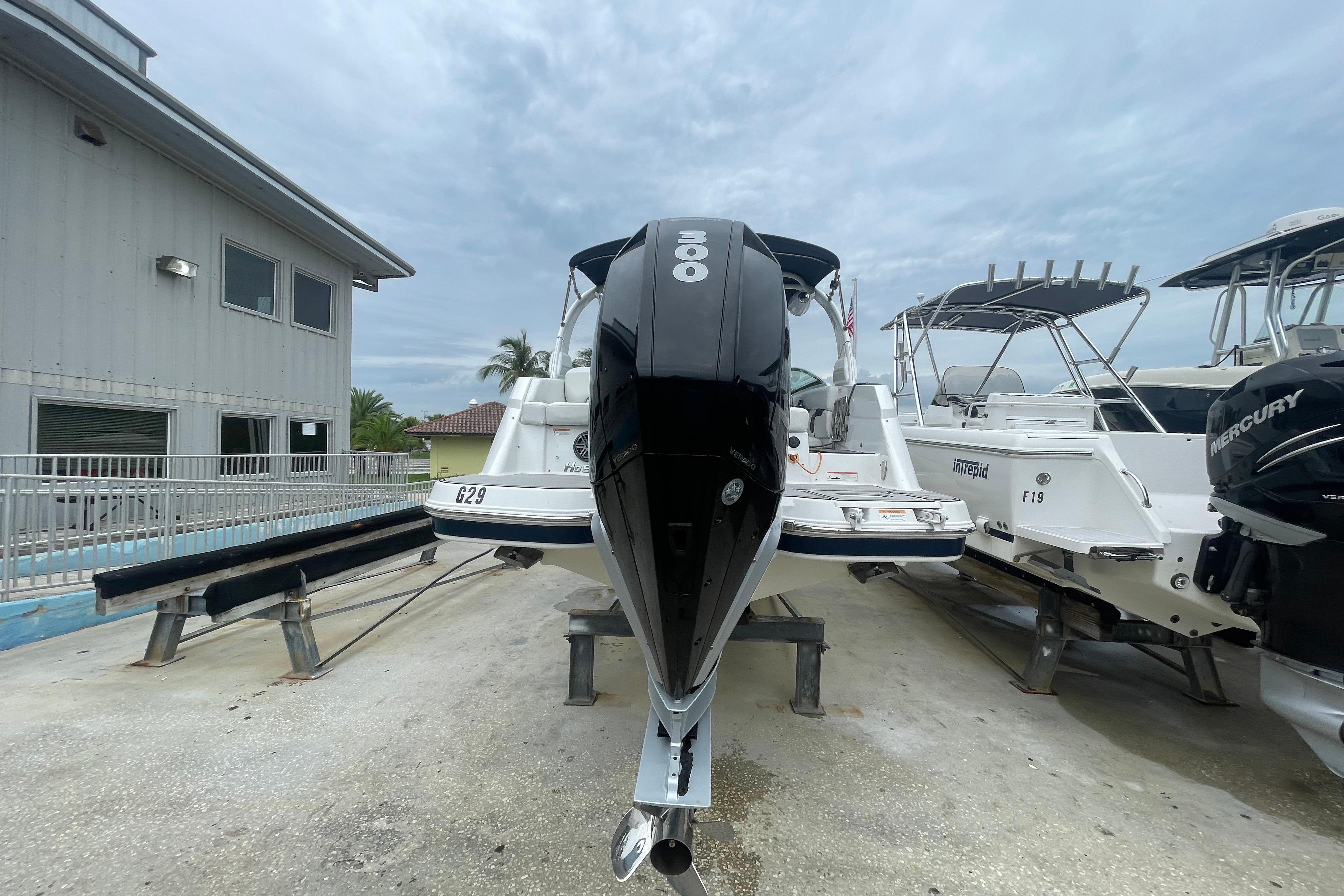 2022 Four Winns HD8 OB boat with 300 horsepower engine, docked outdoors.
