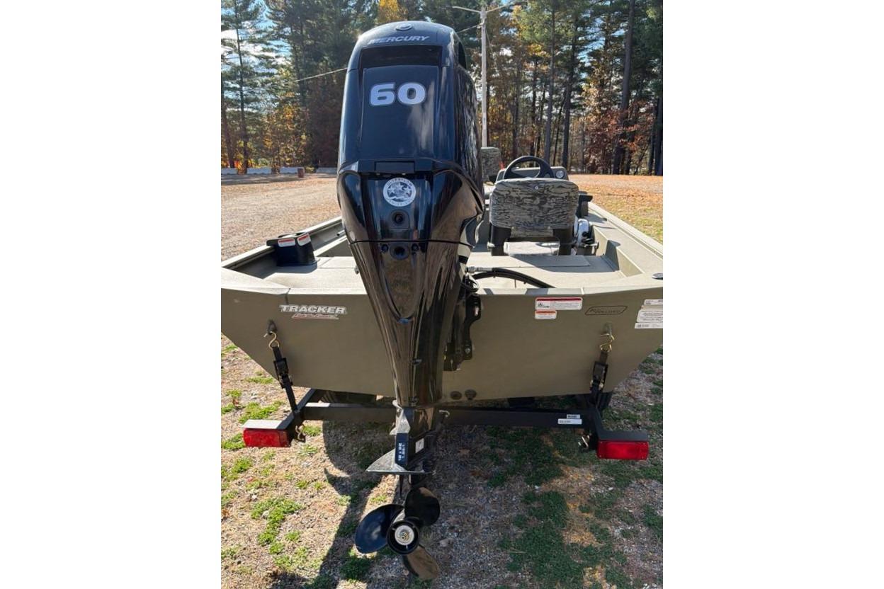 2026 Tracker Grizzly 1754 SC boat with Mercury 60 outboard motor, parked outdoors.