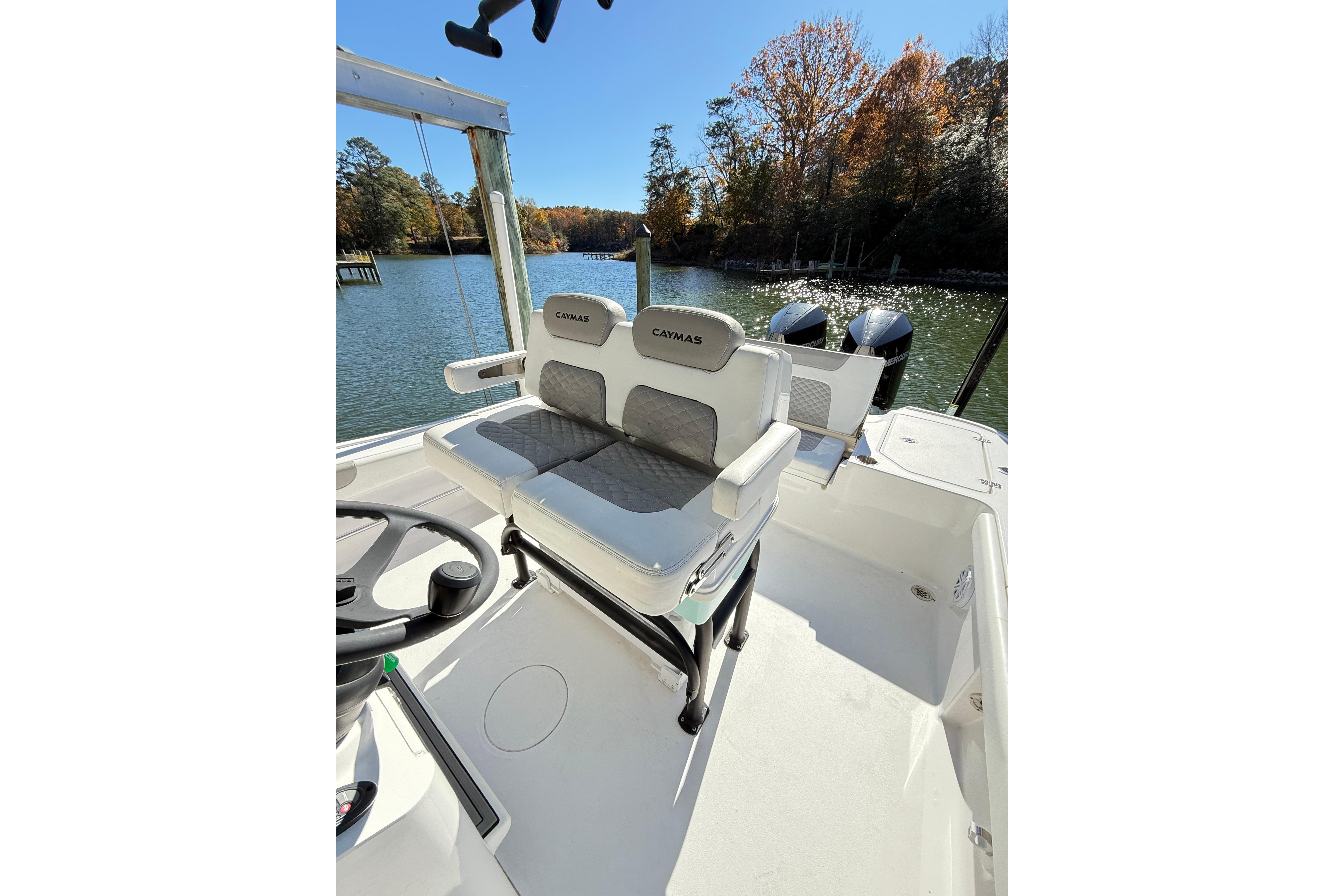 2023 Caymas 281 HB boat interior with dual seats and scenic water view.