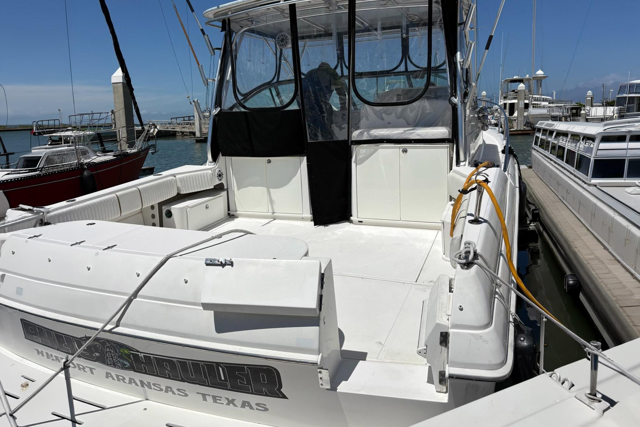 2008 Stamas 370 Express boat docked at marina, featuring spacious deck and clear skies.