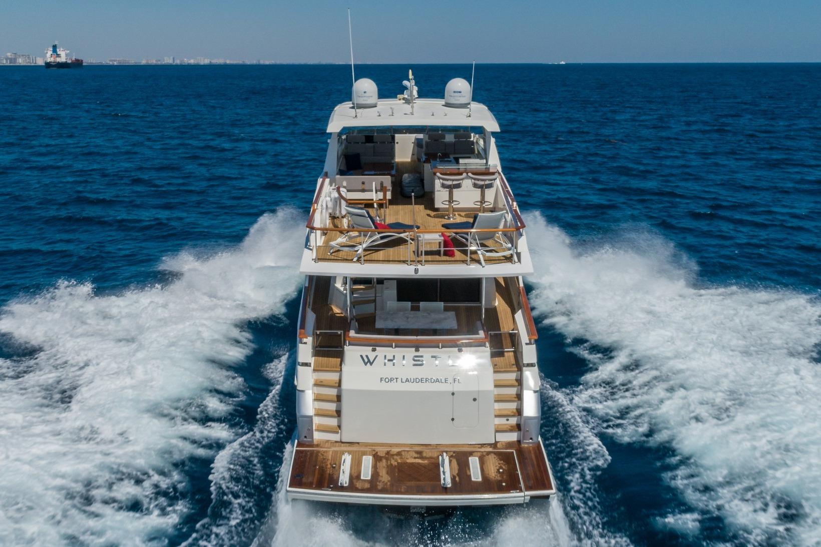 Luxury 2012 Lazzara Breeze yacht cruising on open sea, rear view.