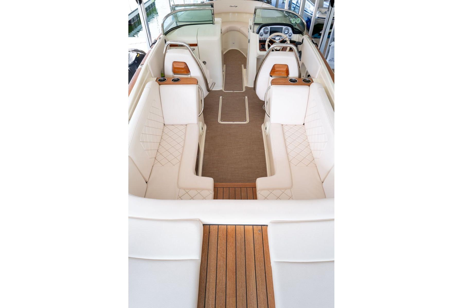 2023 Chris-Craft Launch 27 interior with elegant seating and wooden accents.
