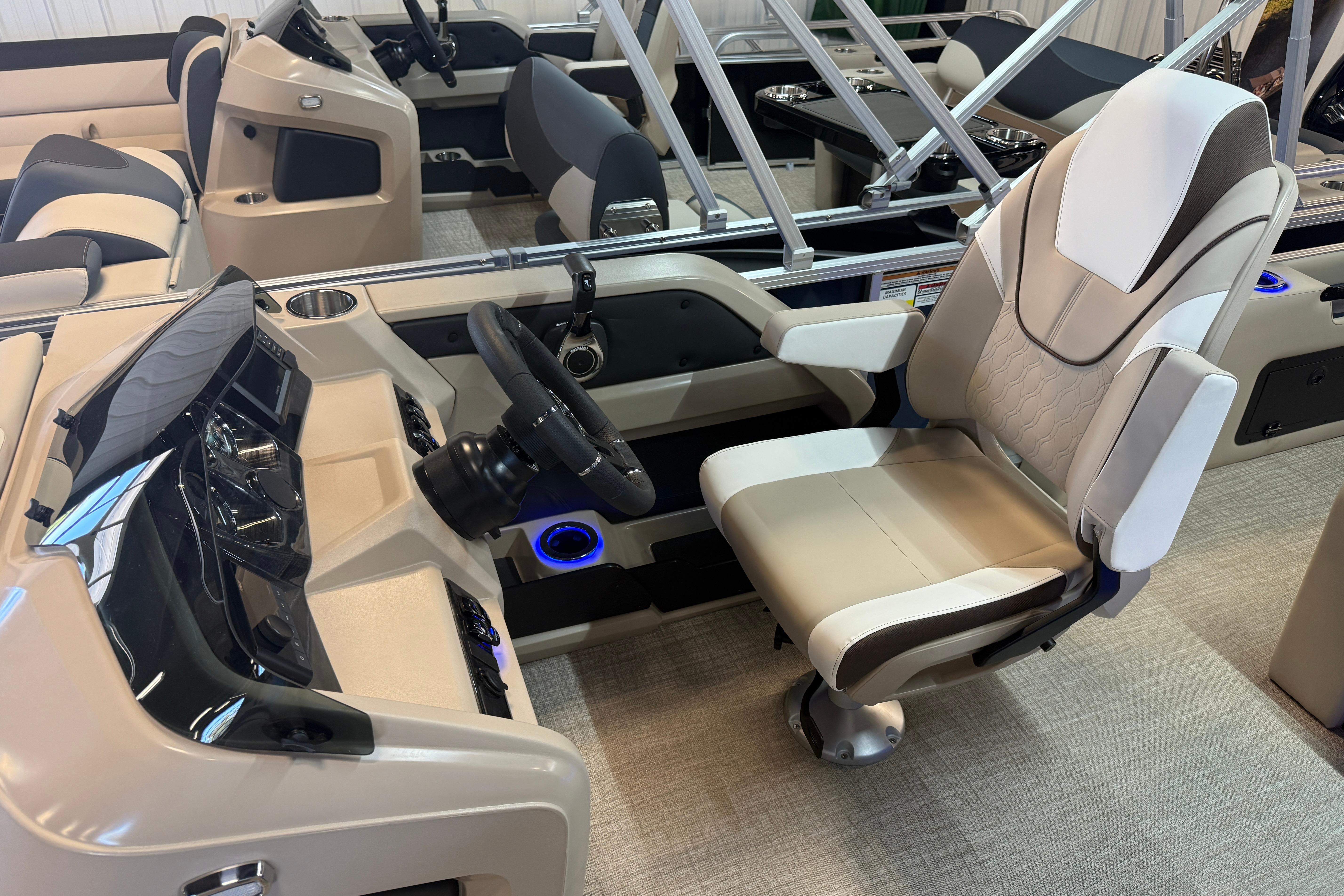 2026 Tahoe Pontoon LTZ Quad Lounger Shift interior with captain's chair and steering console.