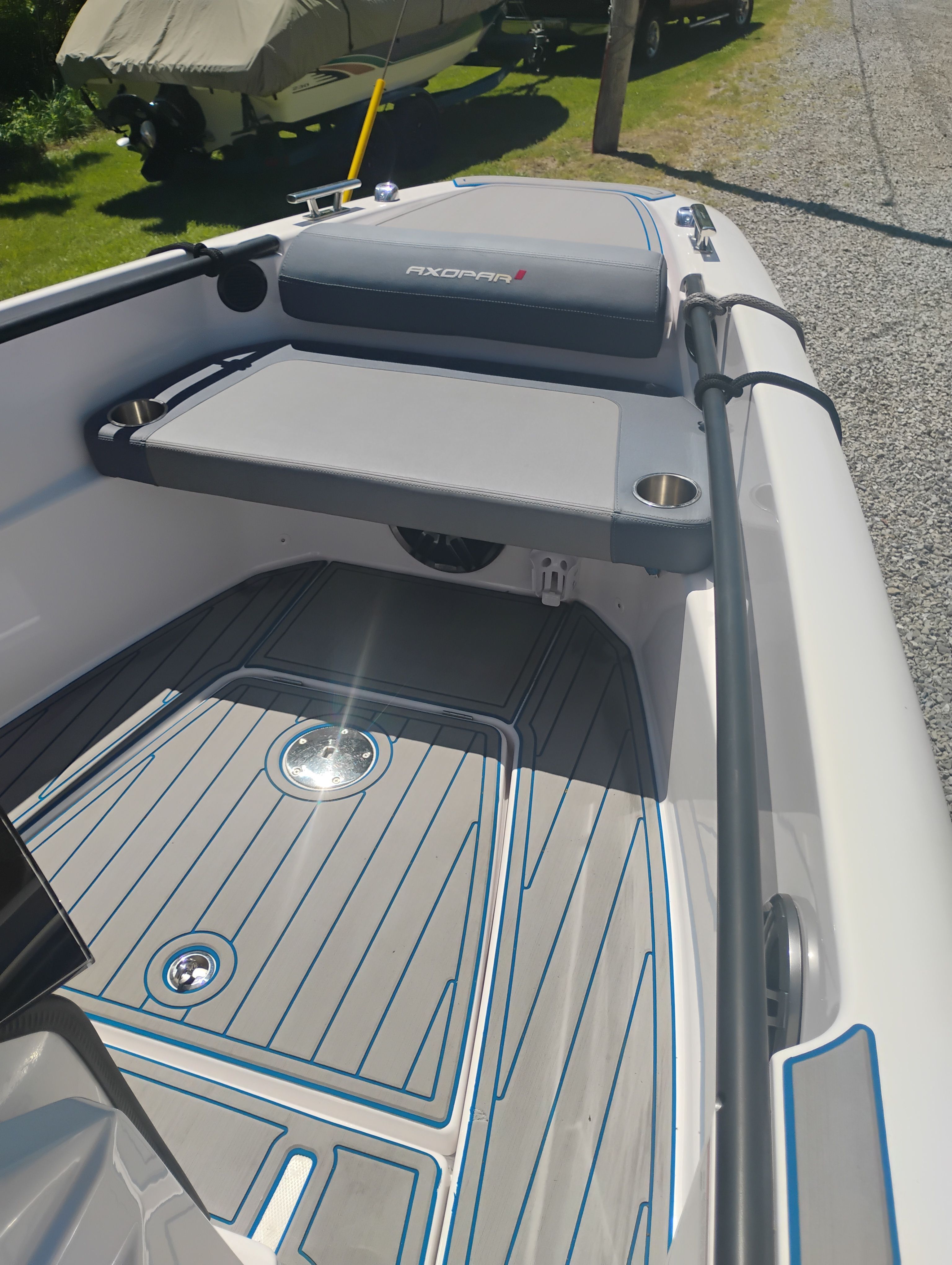 2022 Axopar 22 T-Top boat with gray deck and seating area.
