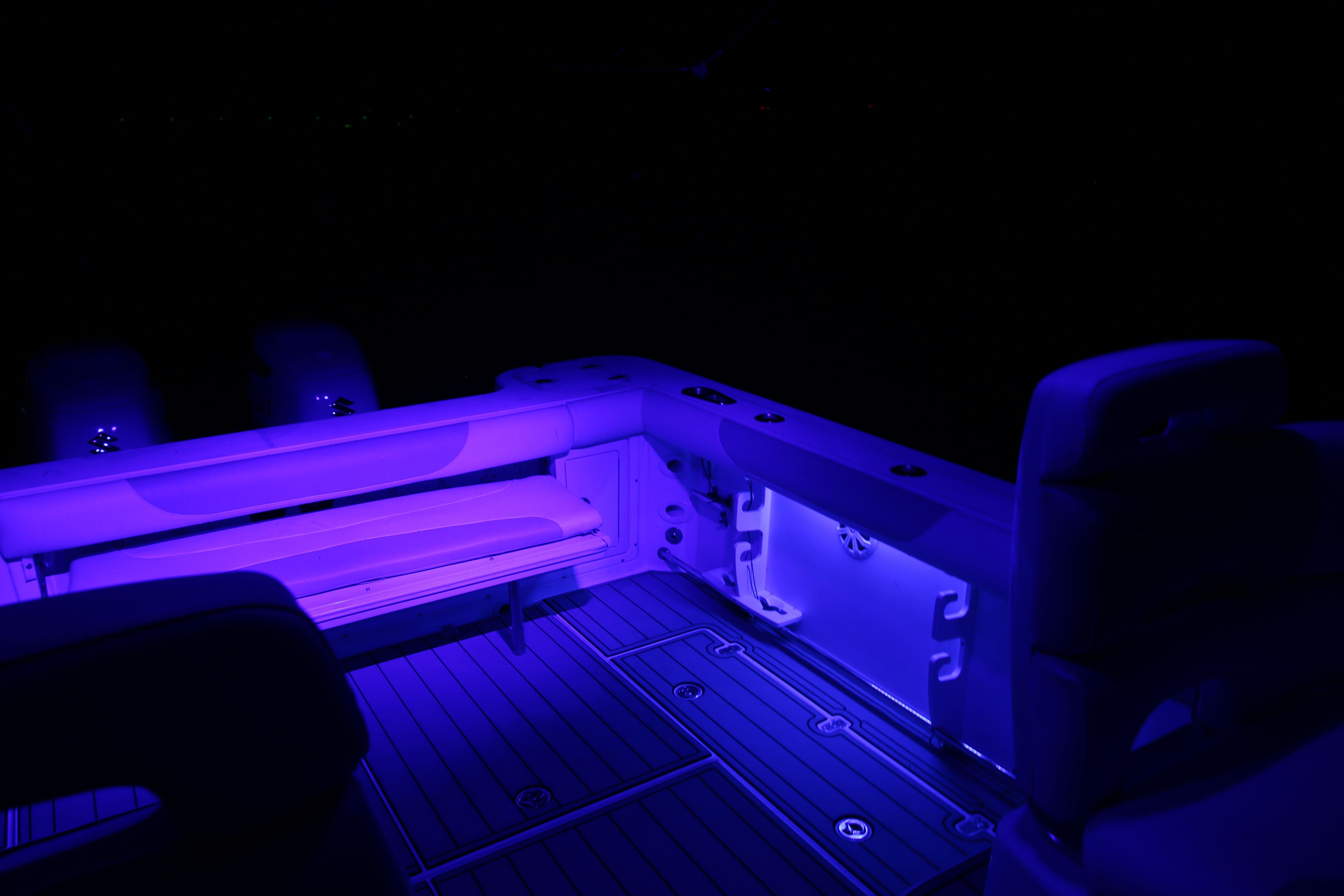 The image shows a boat cockpit illuminated with blue lighting.