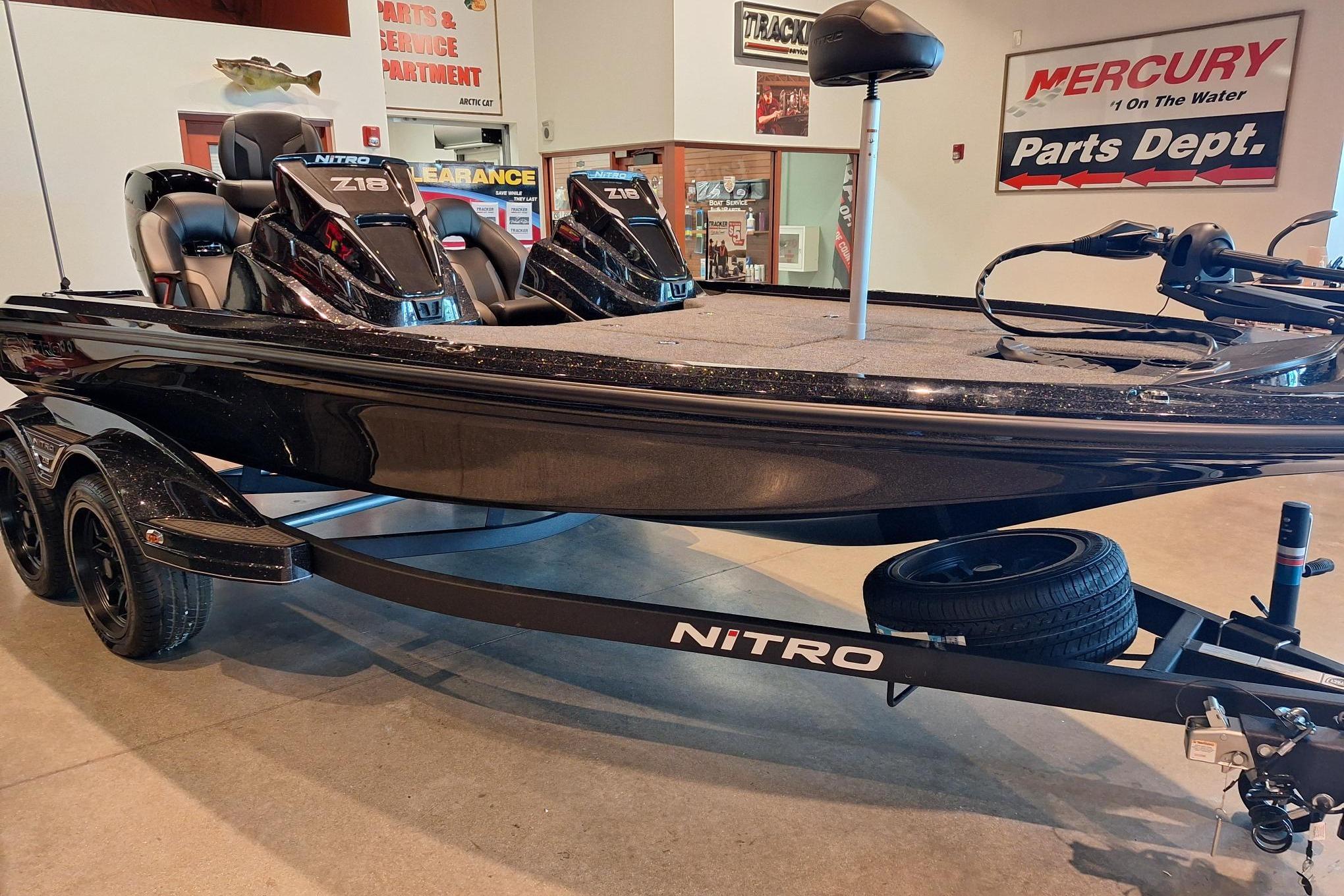 2026 Nitro Z18 boat displayed in showroom, featuring sleek black design and dual seating.