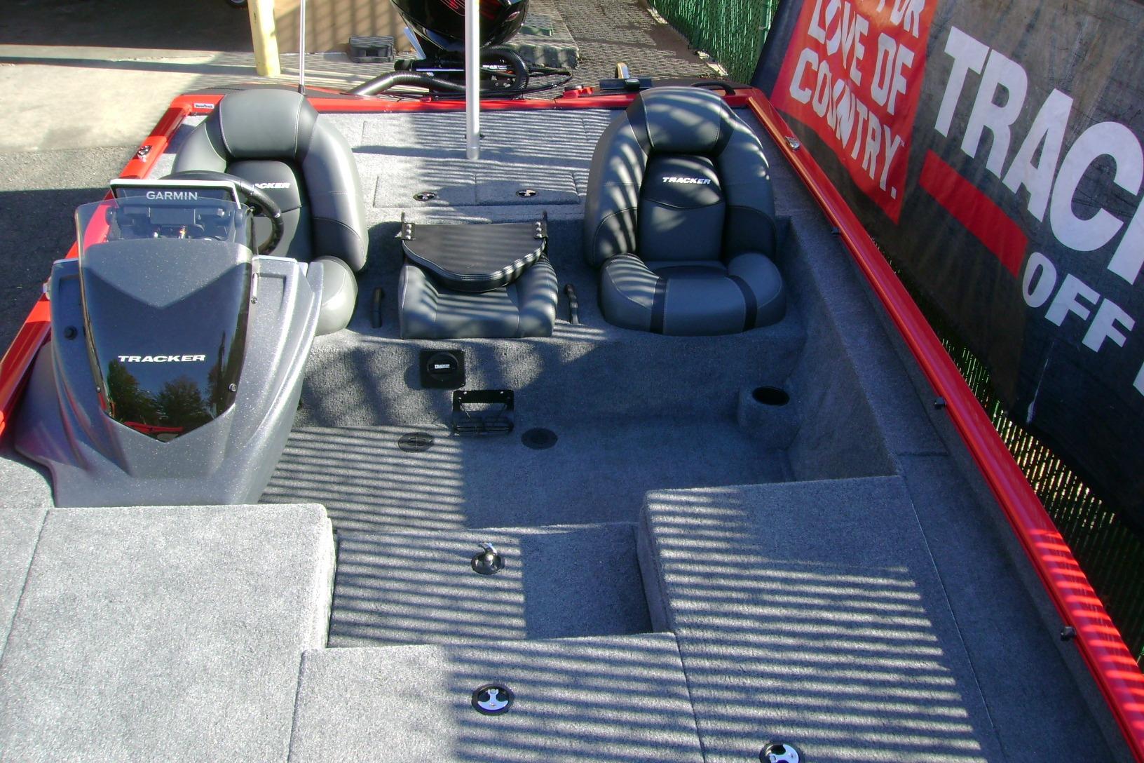 2026 Tracker Savage 215 boat interior with seating and Garmin console, showcasing modern design.