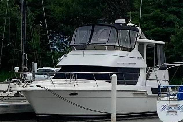 1998 Carver 355 Aft Cabin Motor Yacht docked at marina.