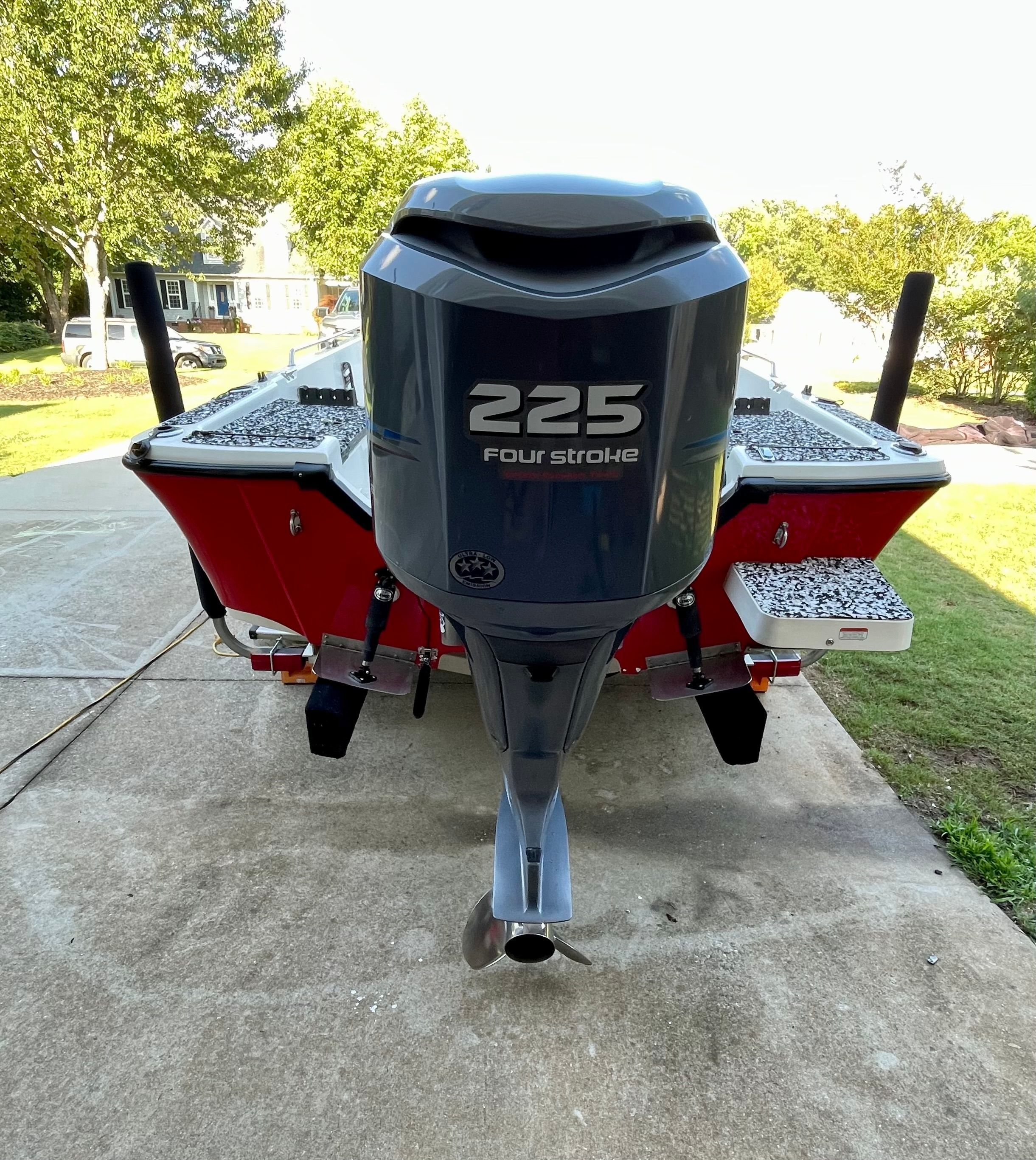 A red 2006 Mako 2101 Inshore boat with a 225 horsepower four-stroke engine.