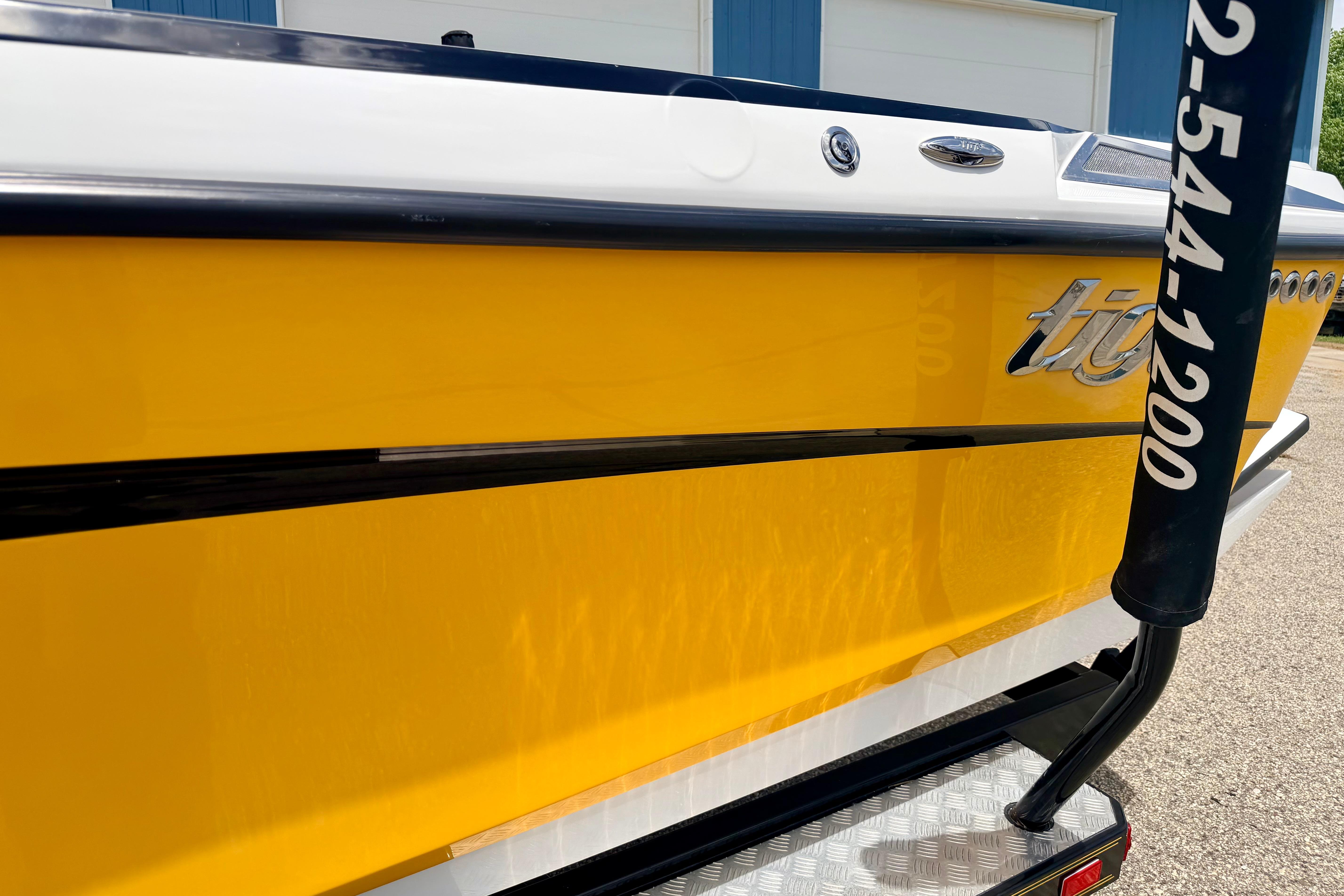2014 Tigé R20 boat with vibrant yellow hull and sleek design.