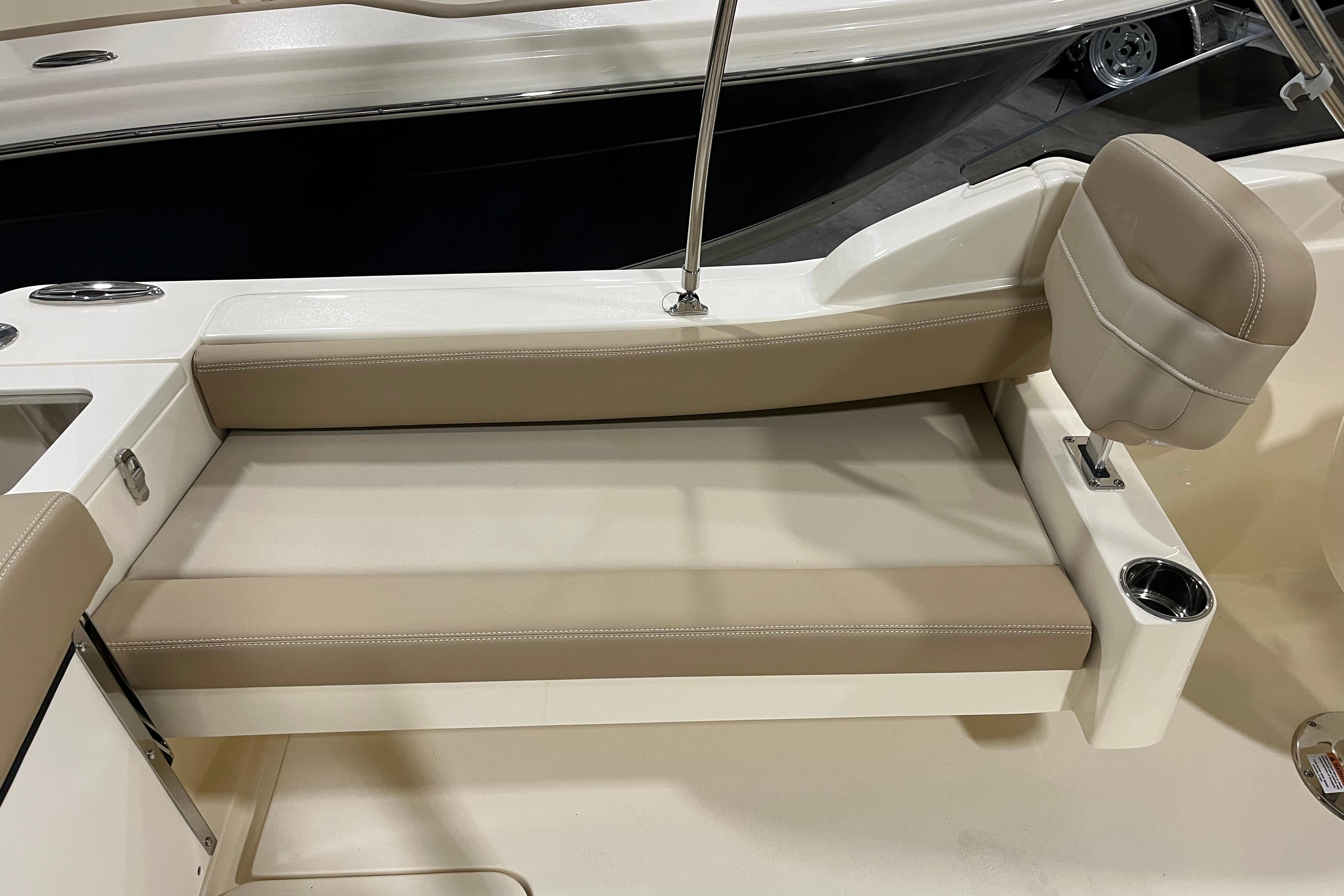 2025 Scout 215 Dorado boat interior with beige seating and cup holder.
