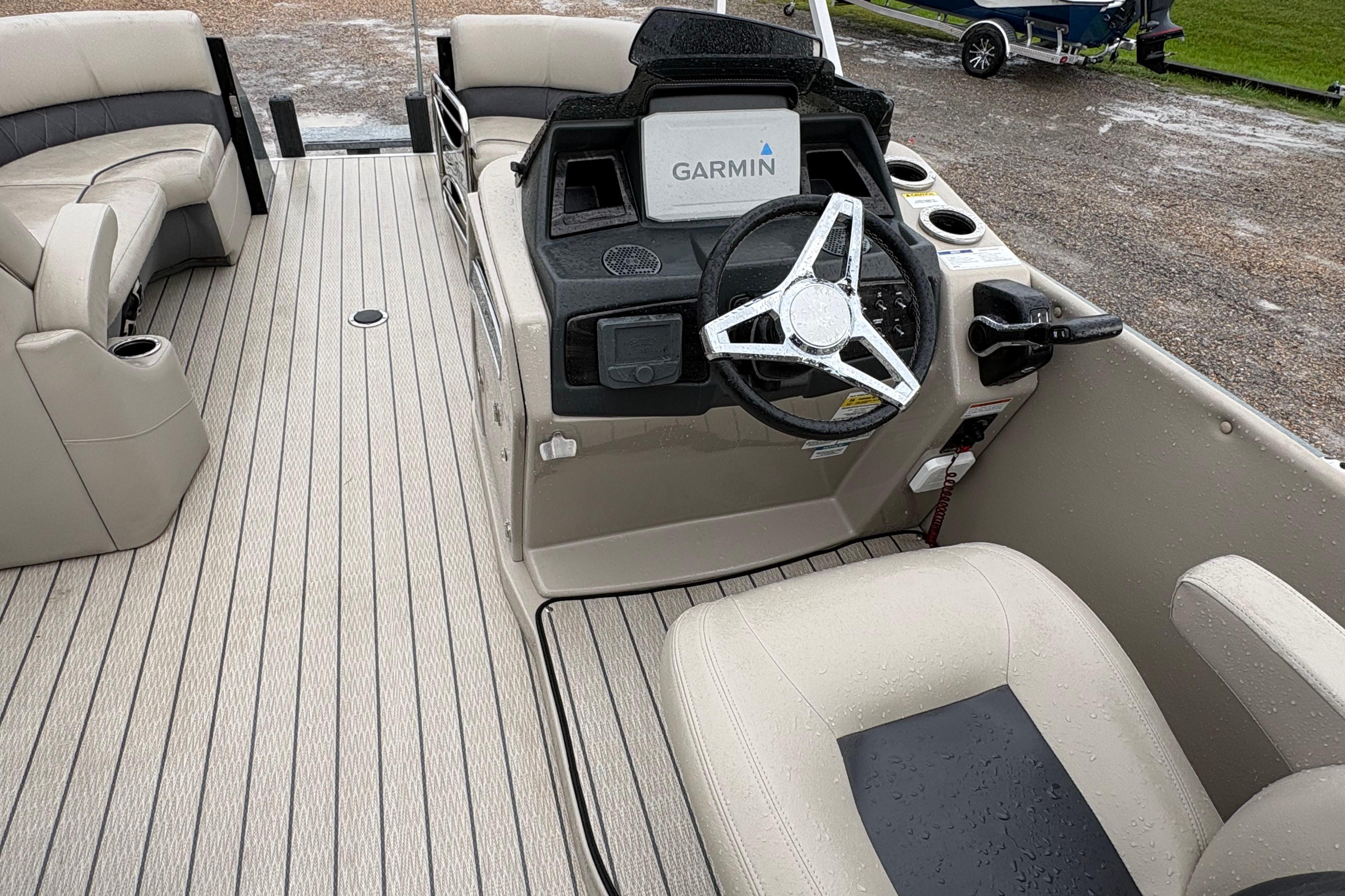 2023 SilverWave 2410 CLS boat interior with Garmin navigation, beige seating, and steering wheel.