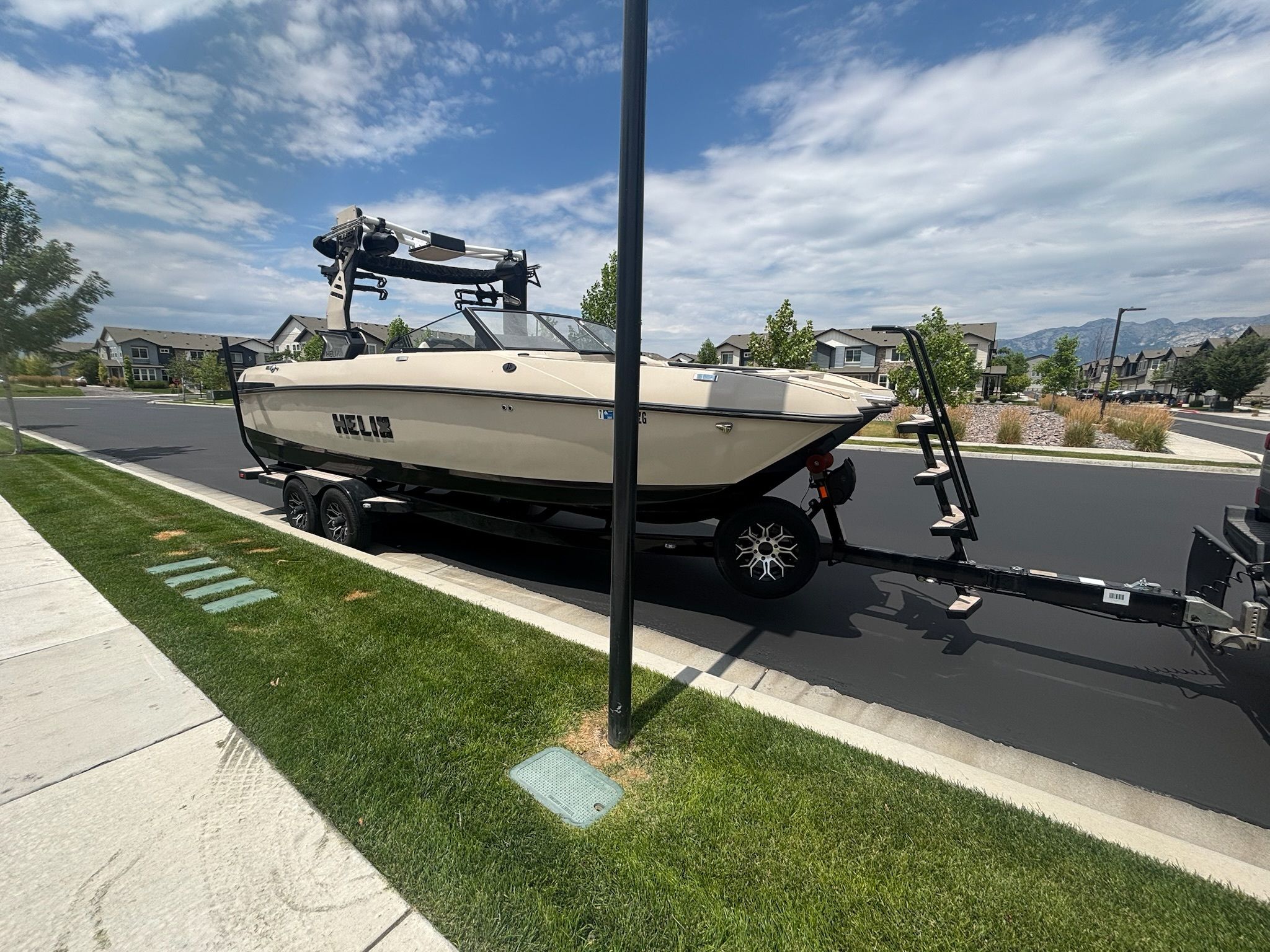 Custom DSB25 boat on trailer in residential area, 2025 model.