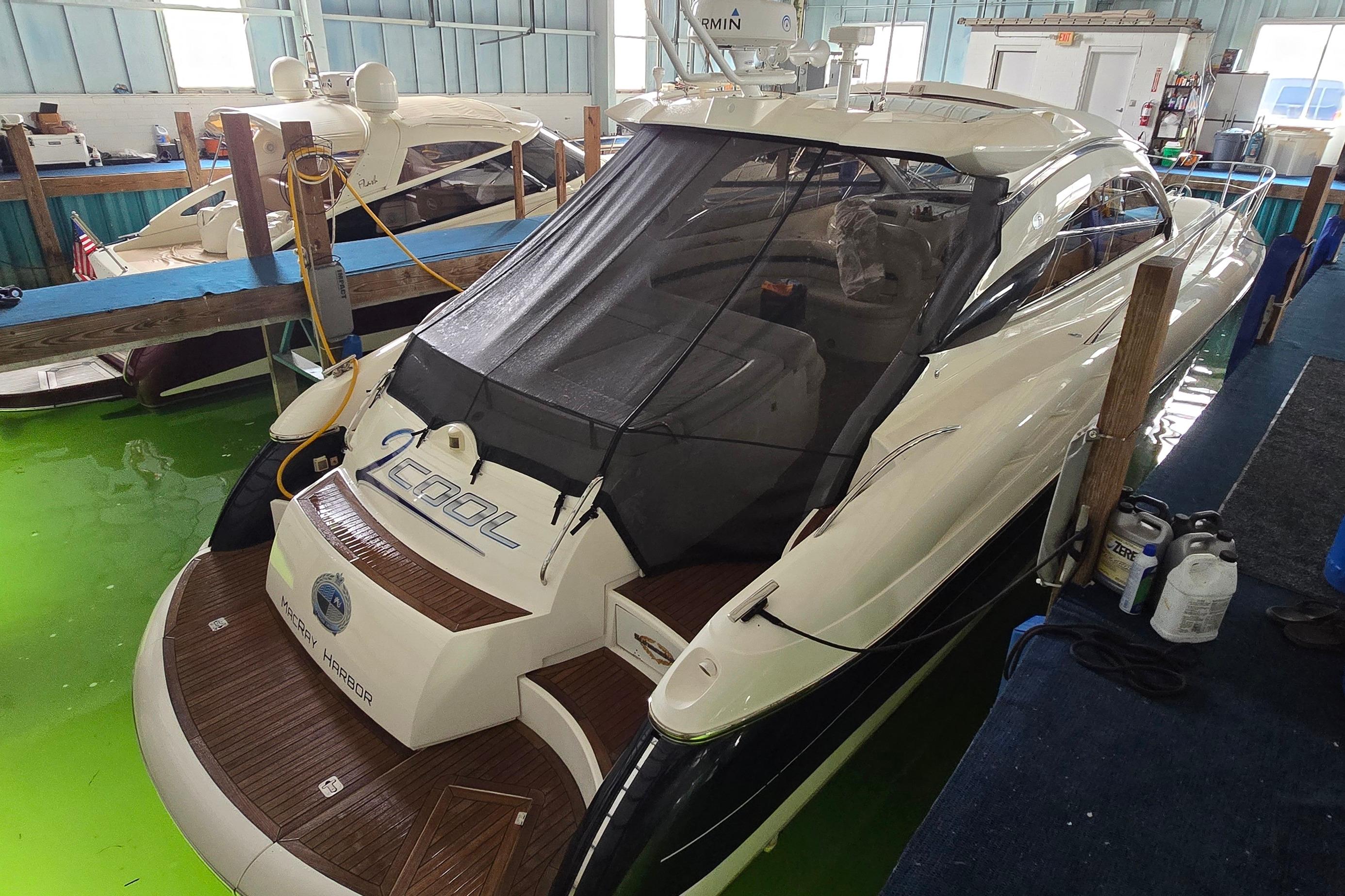 2004 Sunseeker Camargue 50 yacht docked indoors with protective cover.