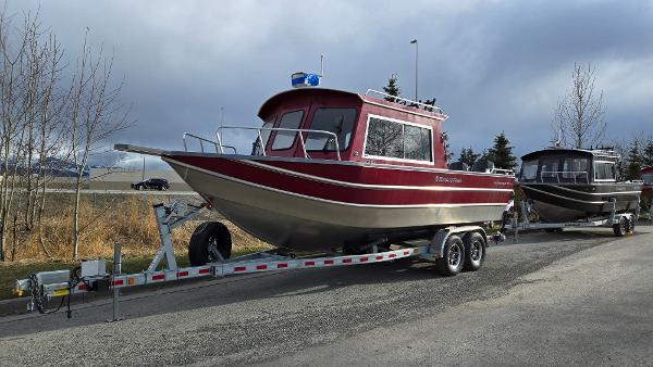 2024 Spartan 24 MAXIMUS PRO XL boat on trailer, parked on roadside.