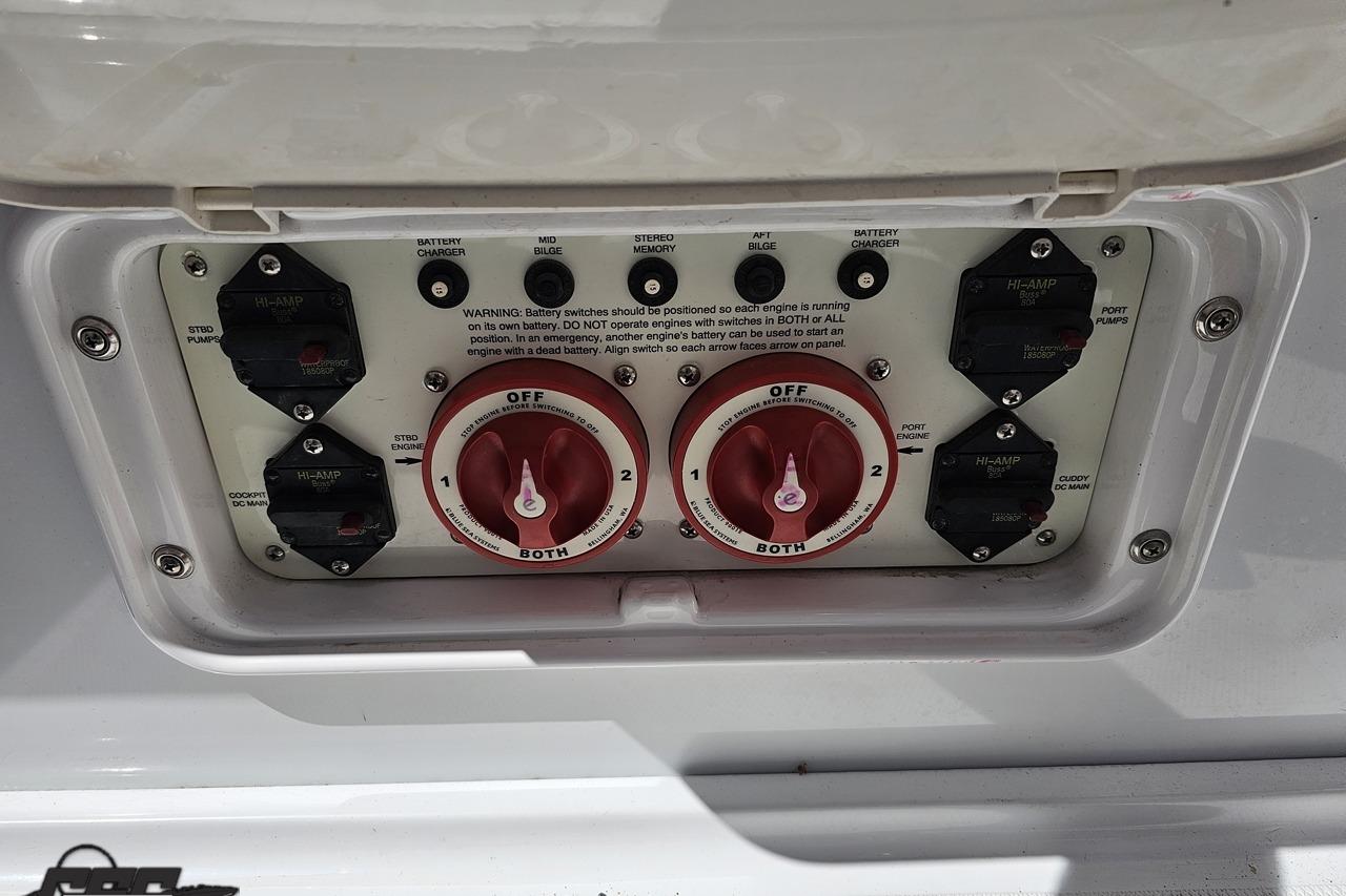 Control panel of a 2005 Baja 30 Outlaw boat with battery switches and circuit breakers.
