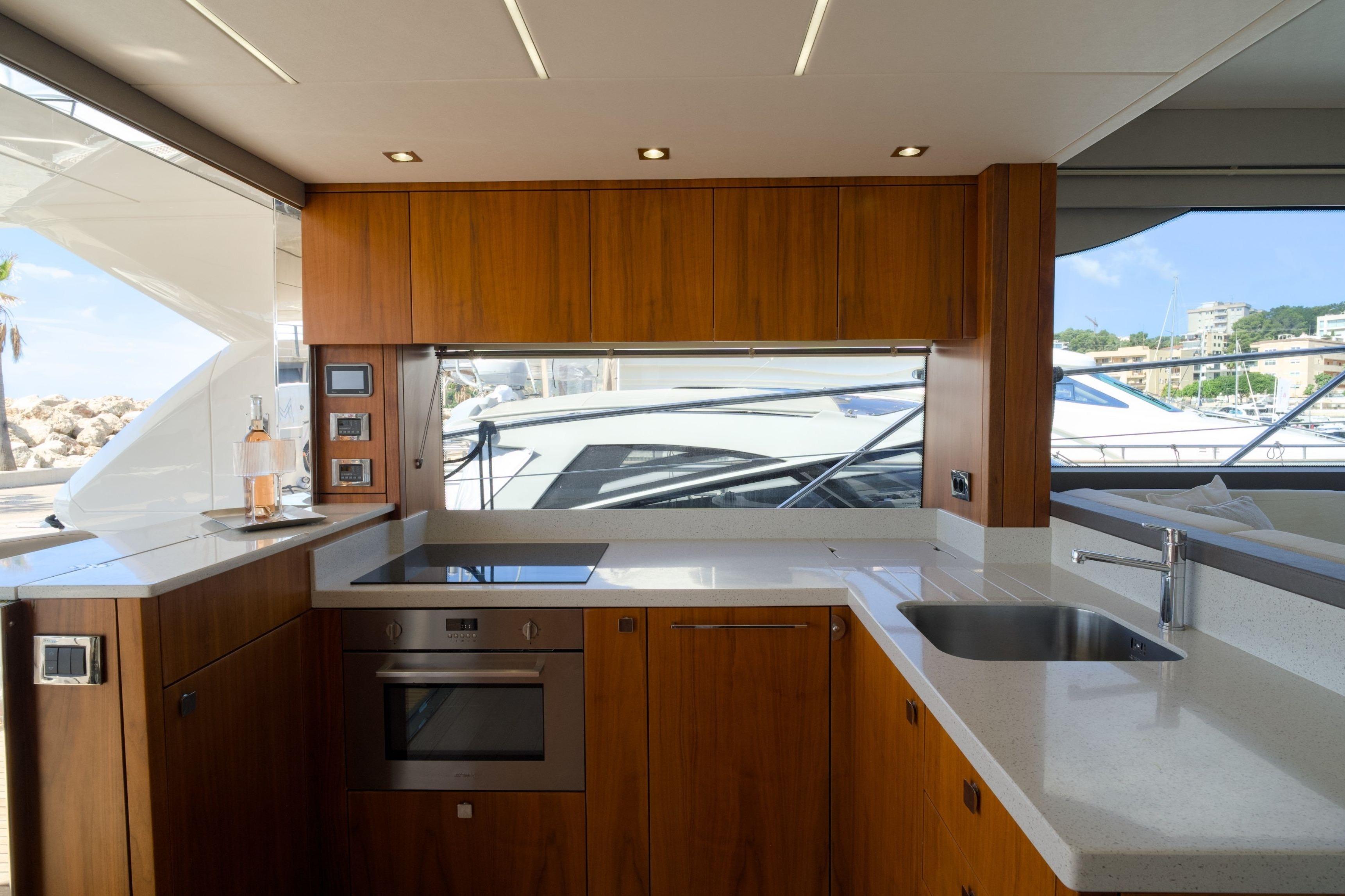 Luxurious kitchen interior of 2019 Sunseeker Manhattan 52 yacht with modern appliances.