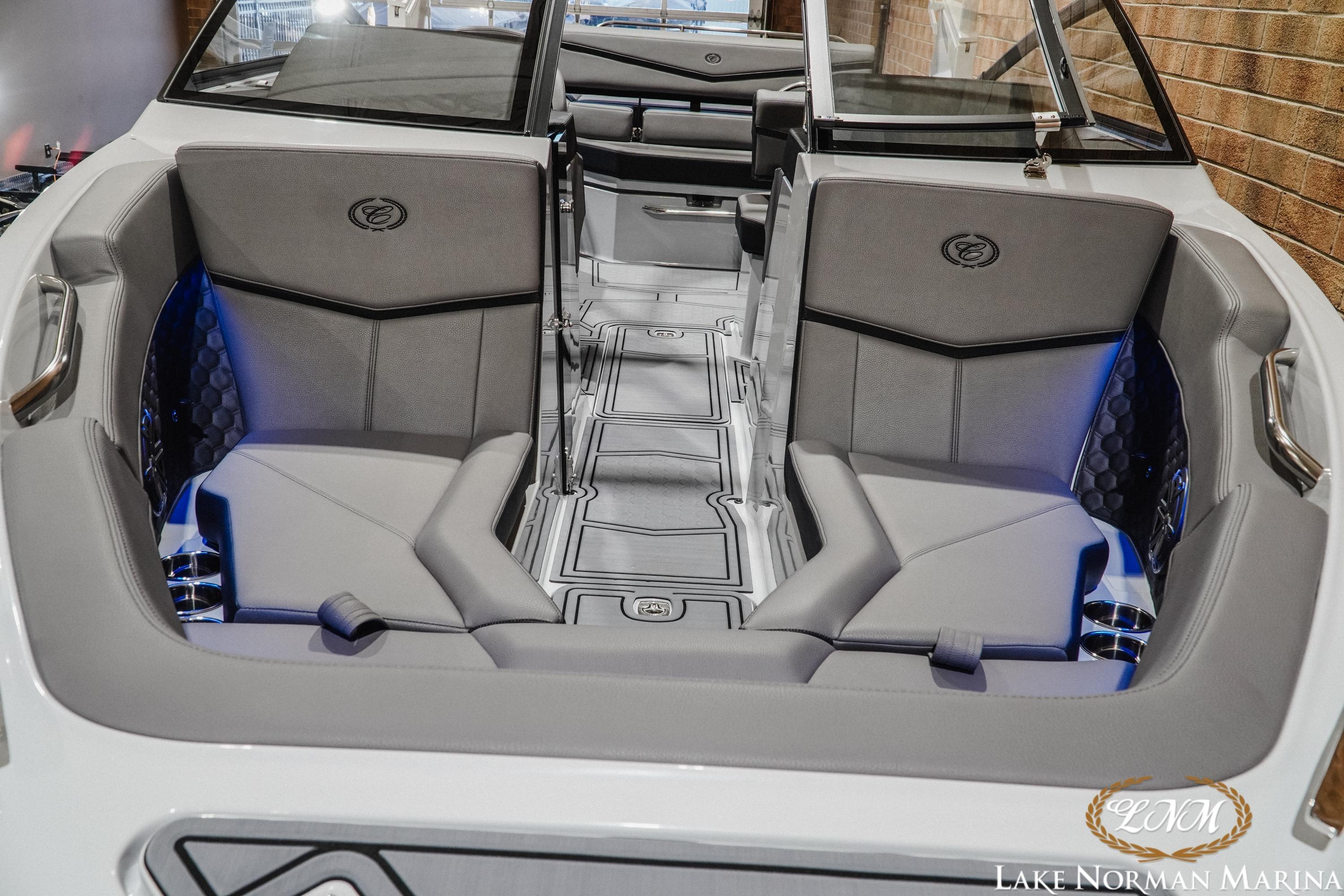 2026 Cobalt R4 Surf boat interior with gray seating and blue accent lighting.