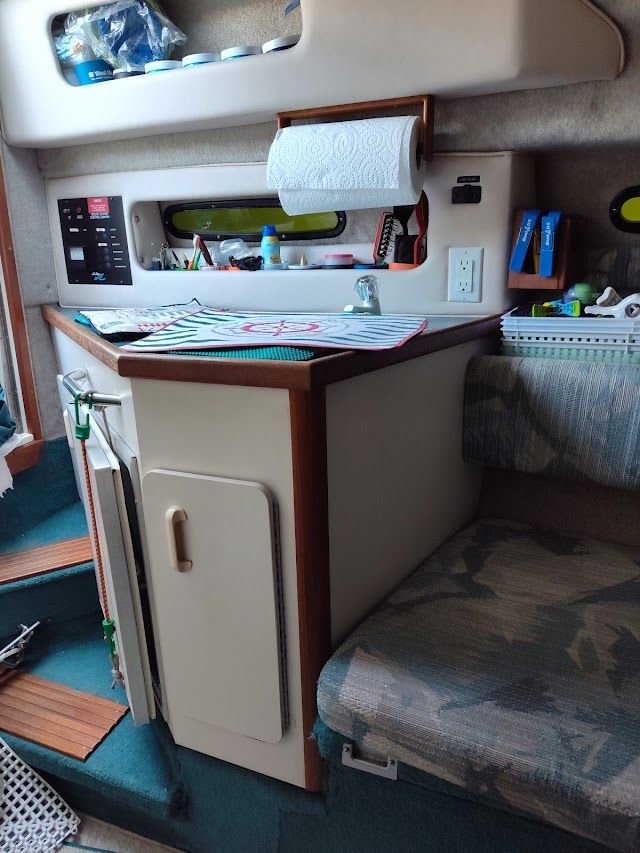 Interior of 1994 Sea Ray 230 Sundancer with kitchenette.