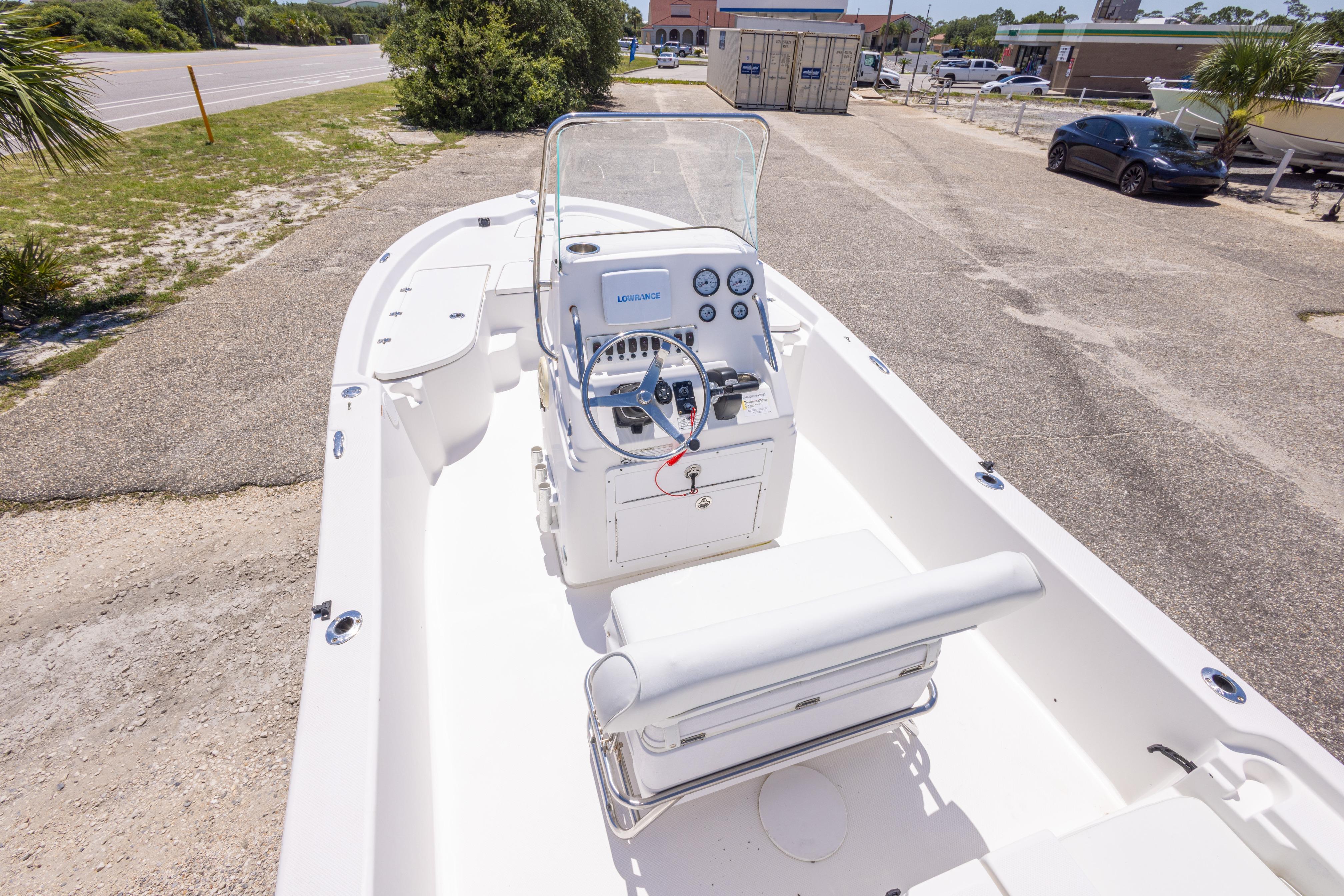 2011 Sea Fox 200XT boat with center console and steering wheel, parked on a sunny day.