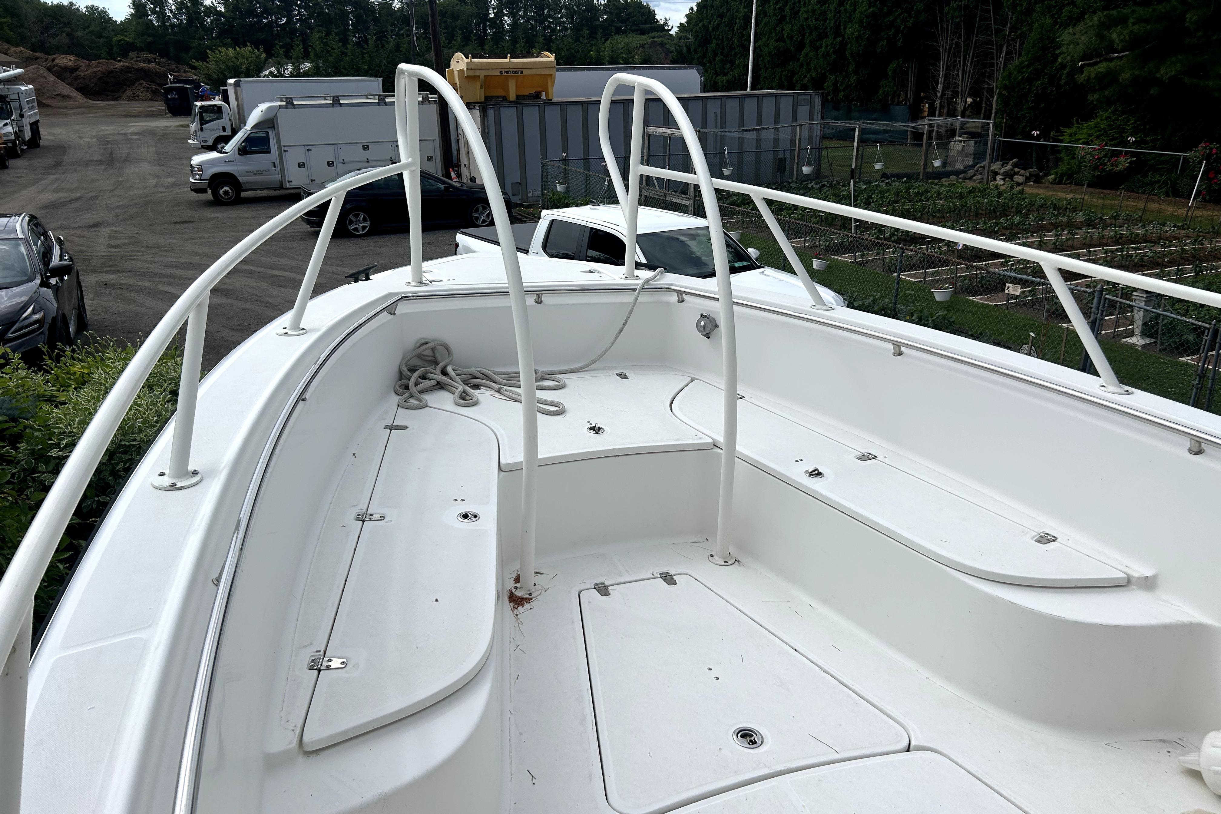 2012 Boston Whaler 320 Outrage boat deck with railing and storage compartments.