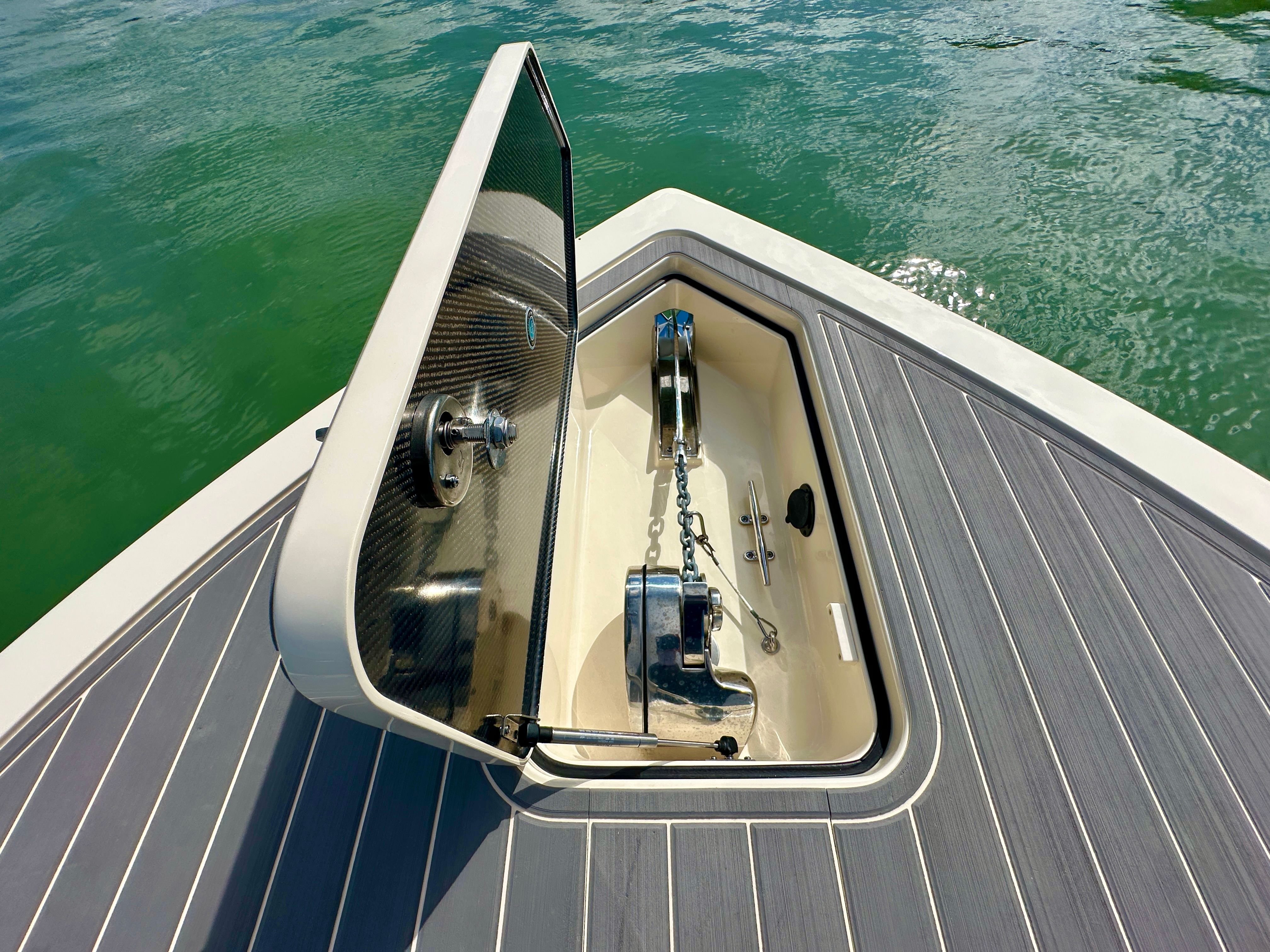 An anchor compartment on a boat with an open lid, revealing the anchor and chain.