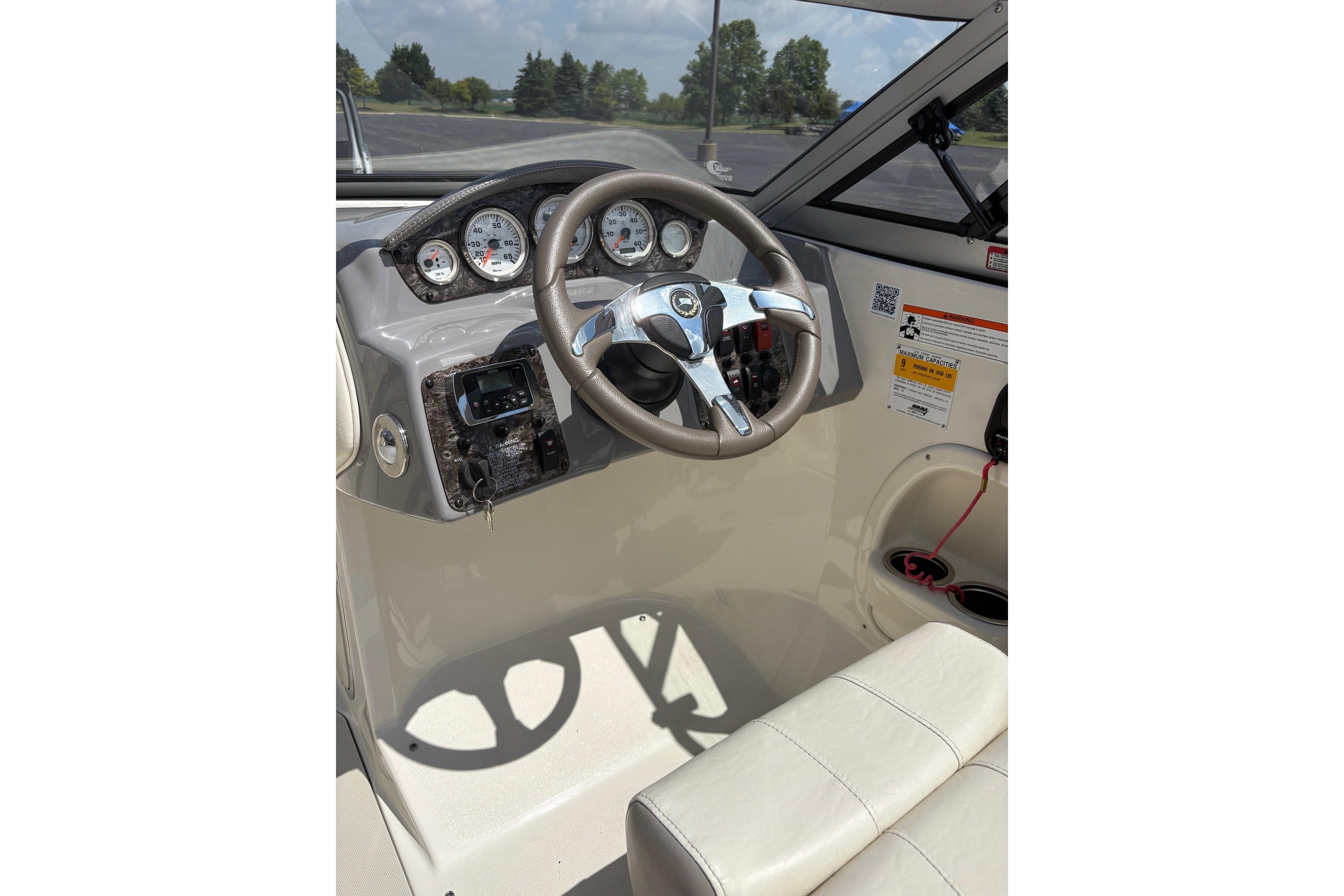 Steering console of a 2013 Stingray 198 LX boat with gauges and controls.