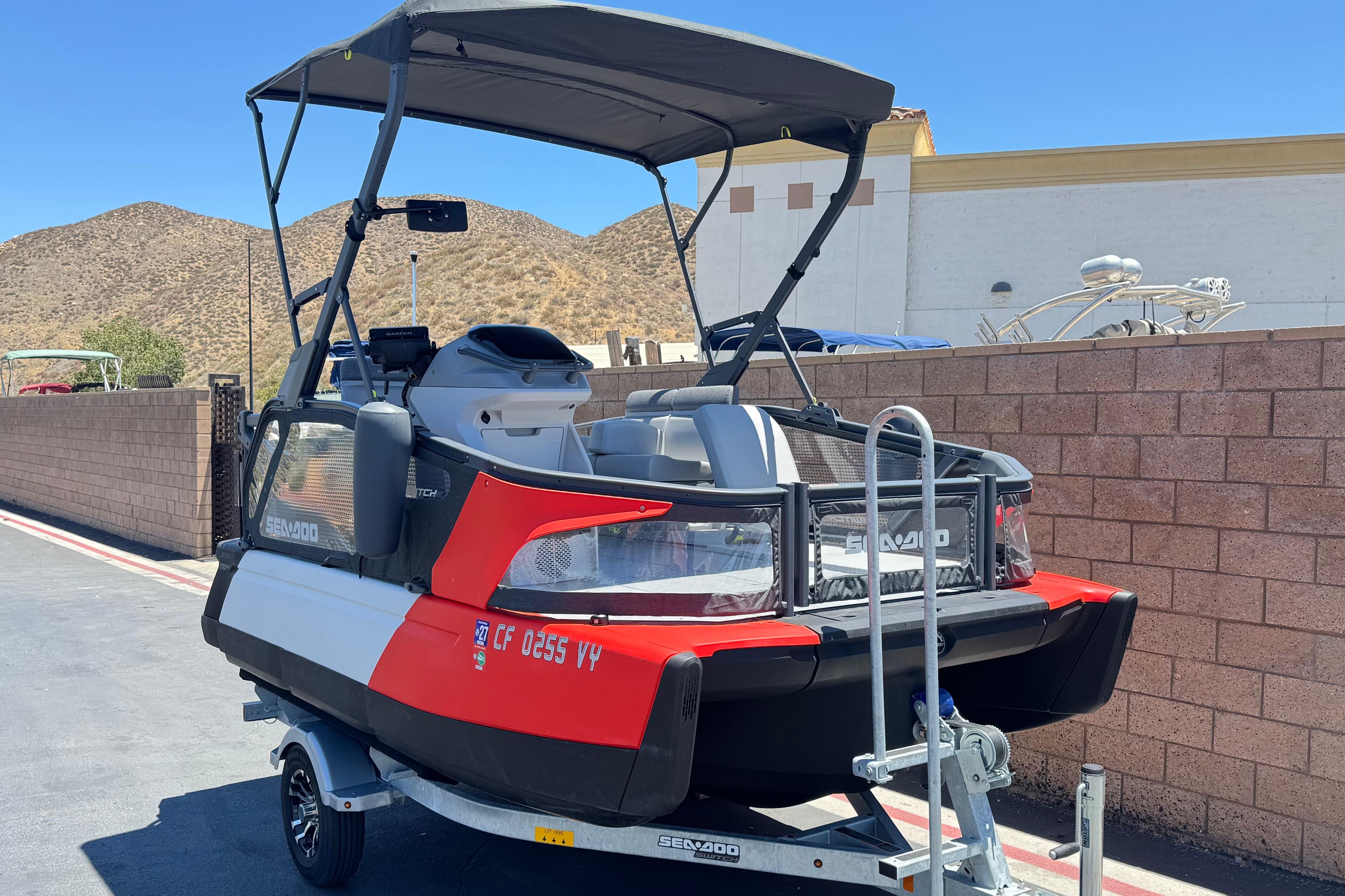 2024 Sea-Doo Switch Compact on trailer, parked outdoors with desert backdrop.