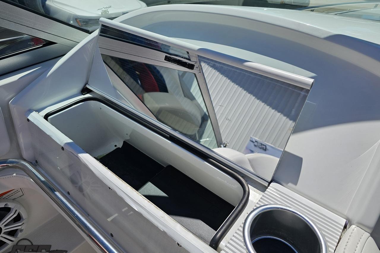 Interior of 2005 Formula 271 FASTech boat showing storage compartment and cup holder.