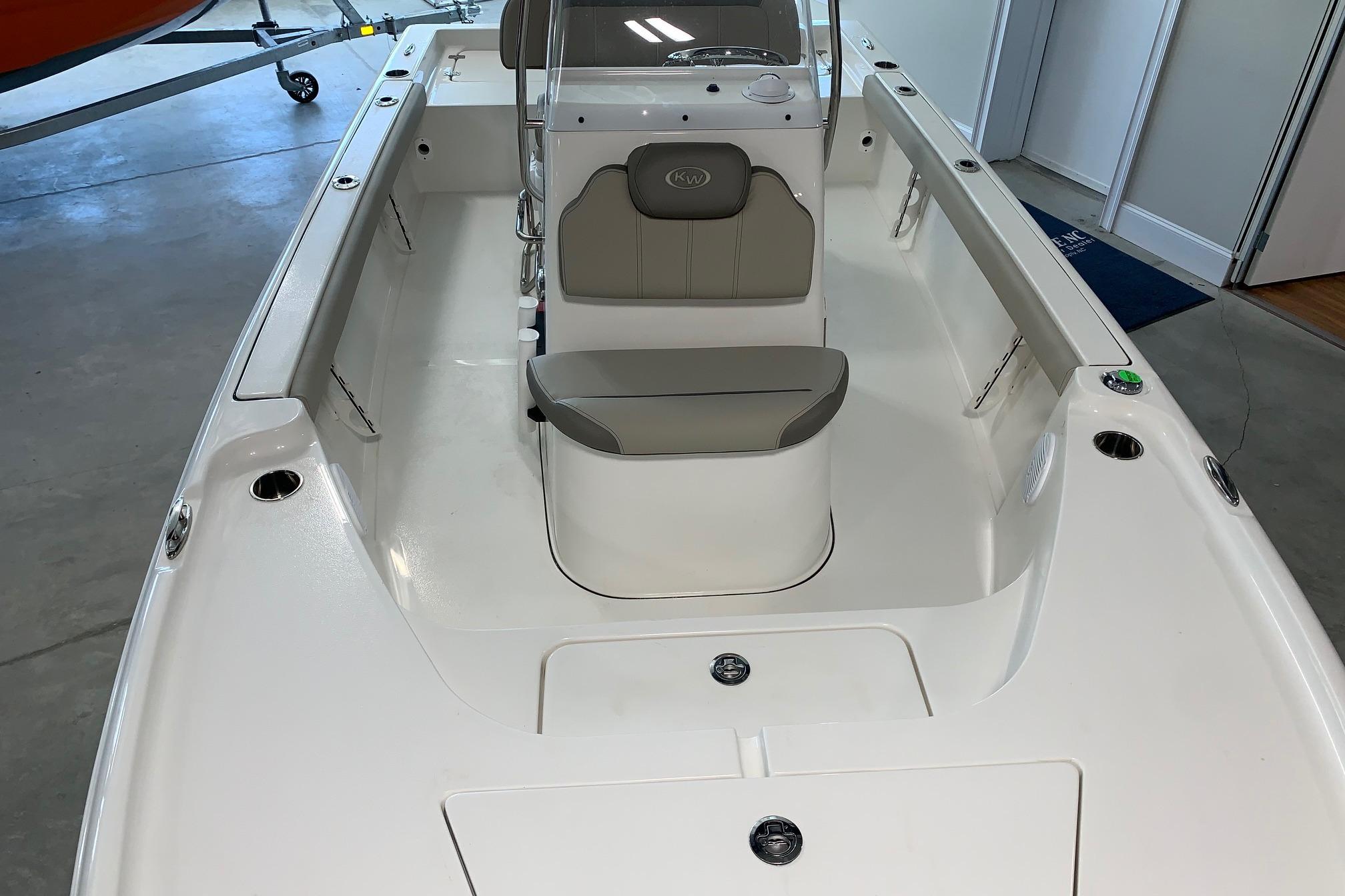 2026 Key West 188 Bay Reef boat interior with seating and console in showroom.