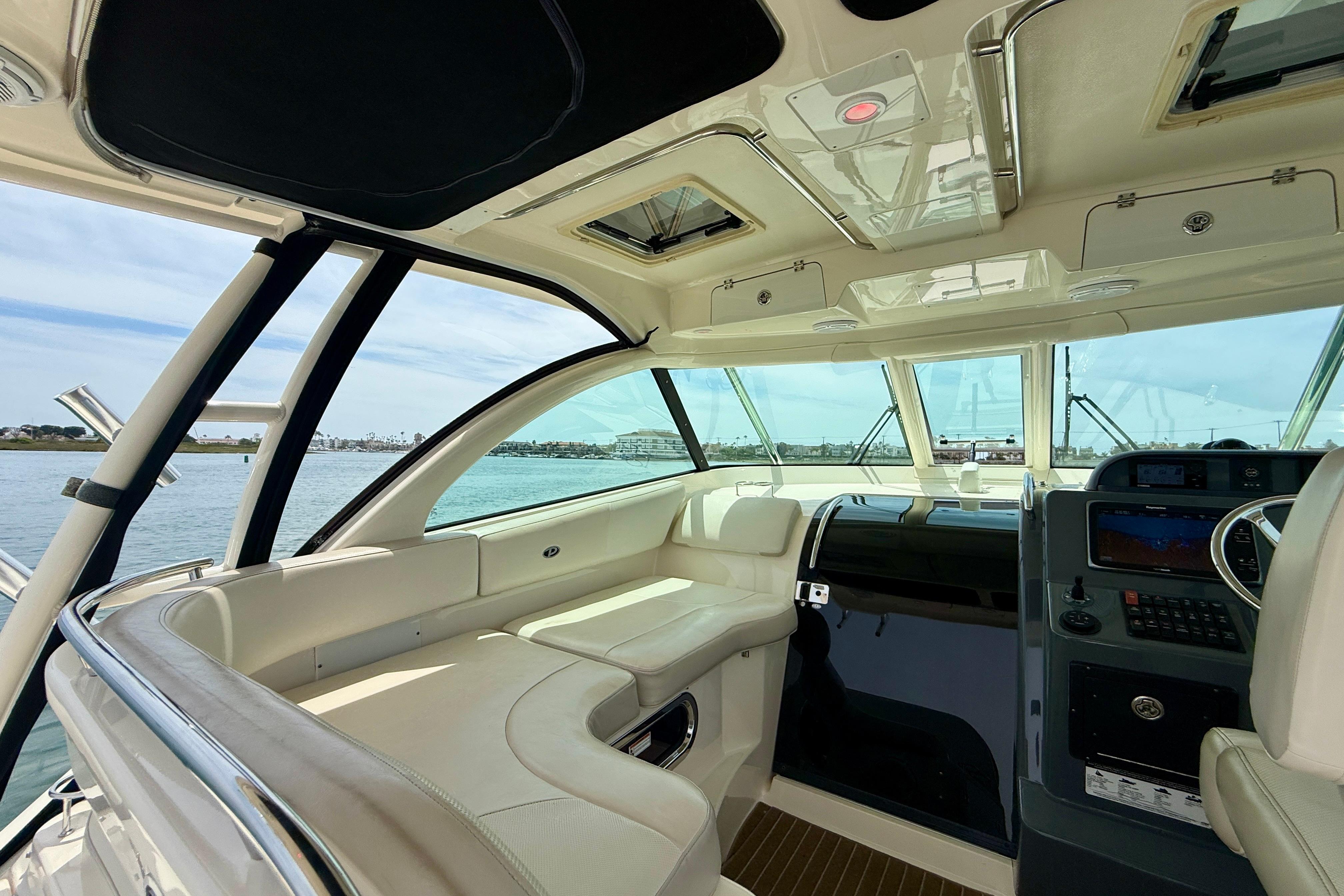 Interior of 2012 Pursuit OS 345 Offshore boat with luxurious seating and navigation controls.