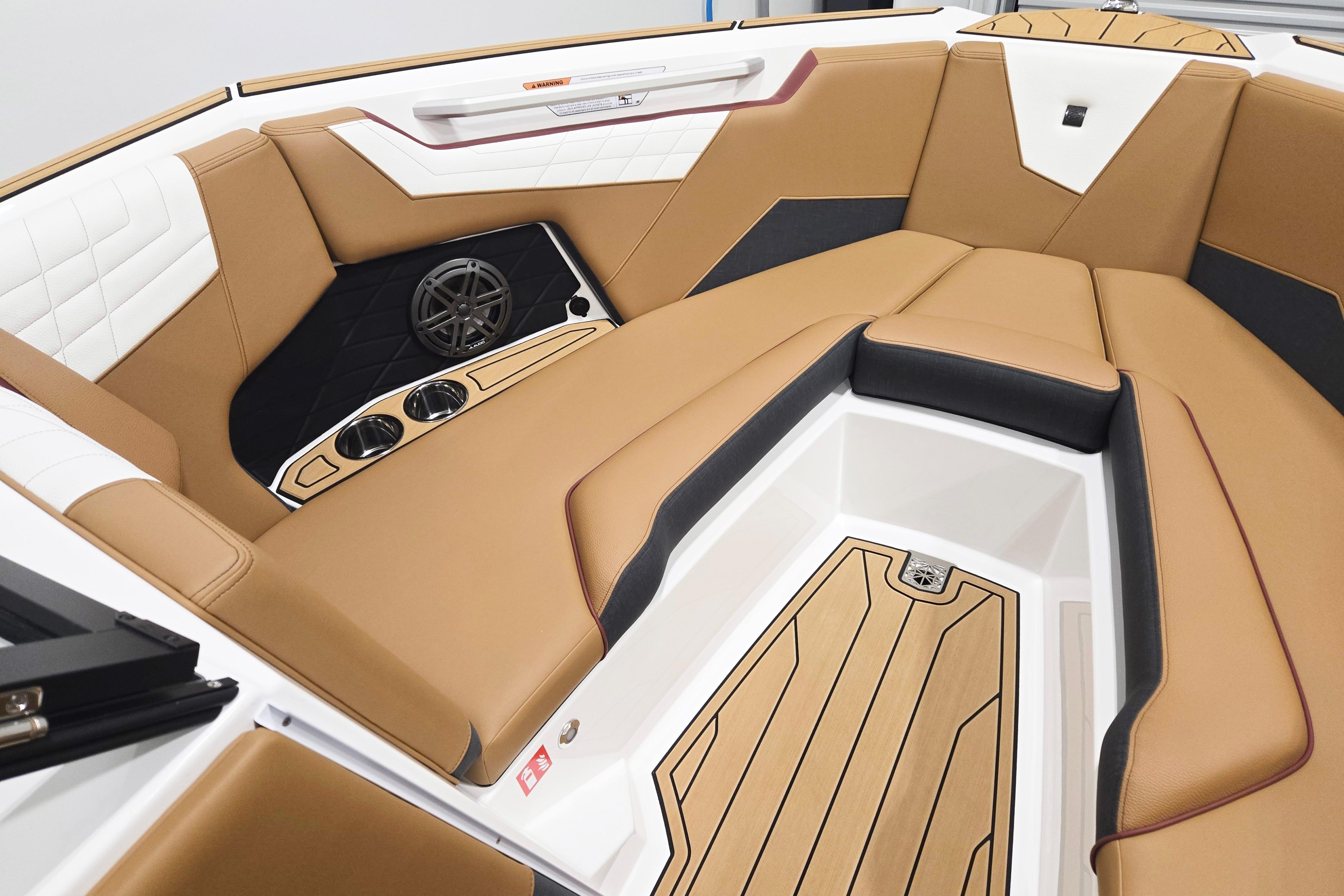 Luxurious interior of 2026 Nautique Super Air Nautique S23 boat with tan seating.