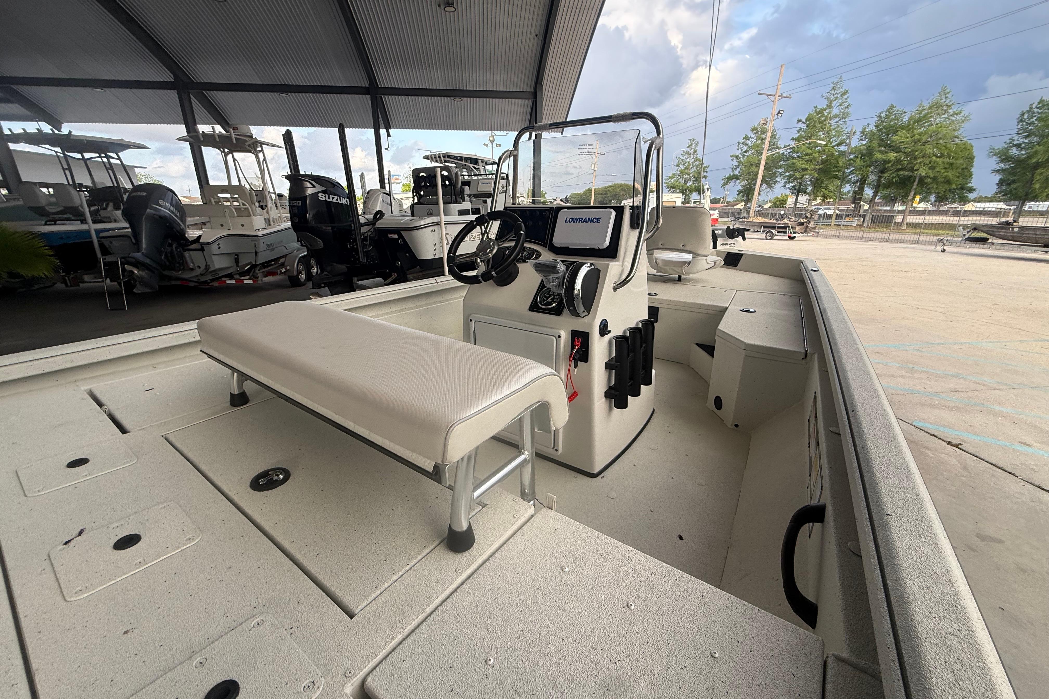 2026 Ranger RB190 boat interior with console, seating, and storage under a covered area.