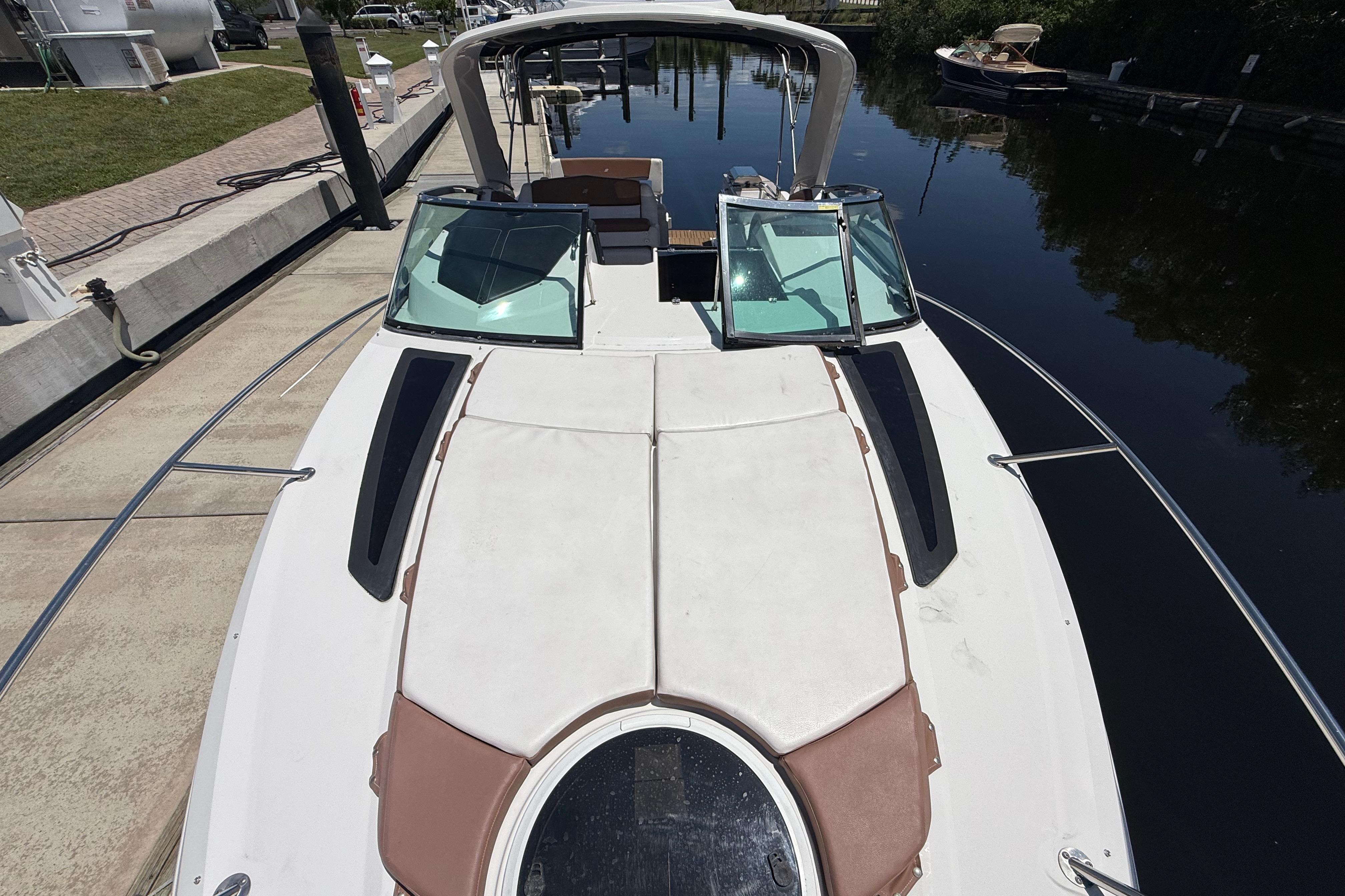 2017 Four Winns V275 boat docked, showcasing spacious deck and sleek design.