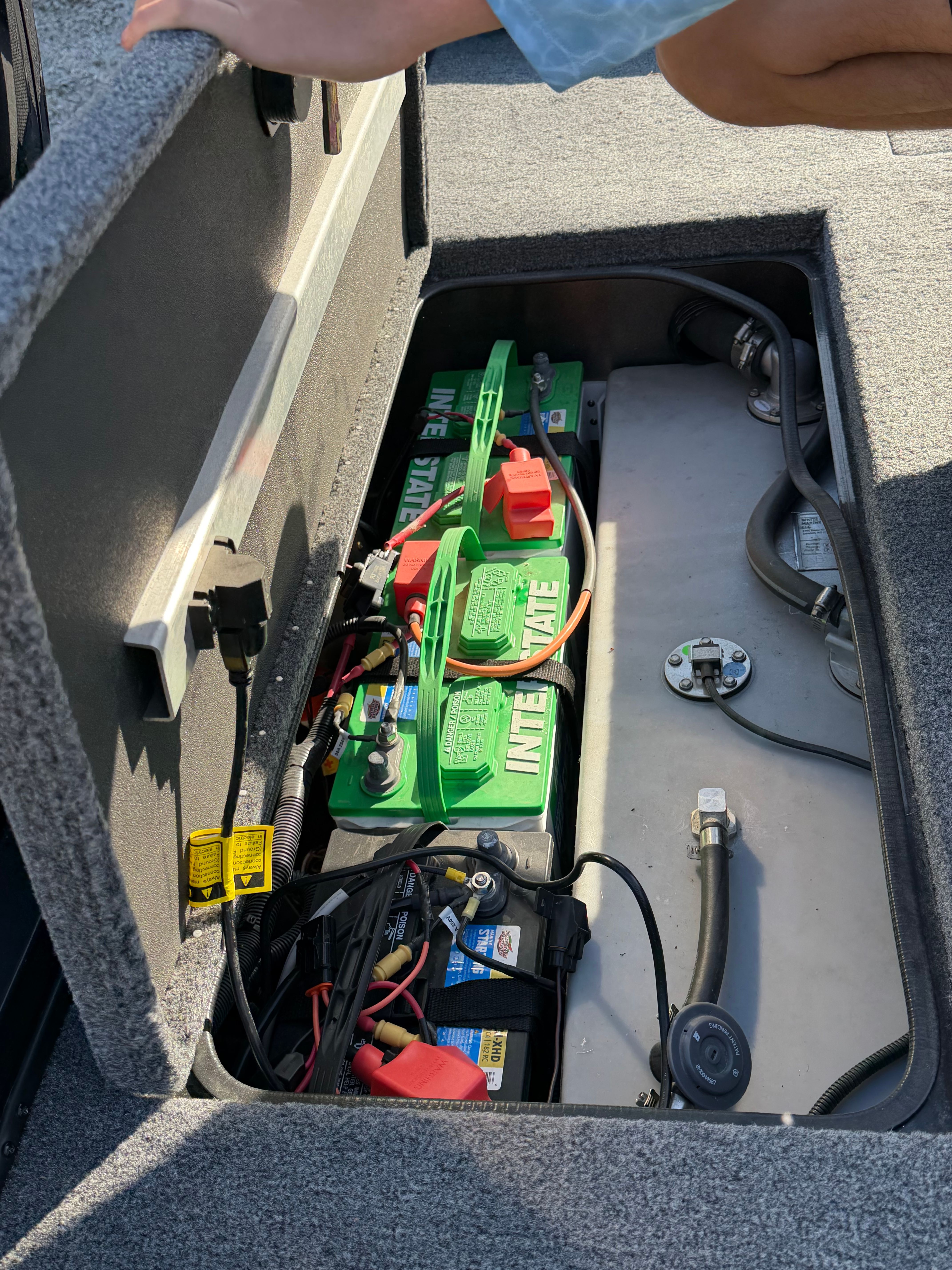 Battery compartment of 2024 Ranger RT188 boat with green batteries.