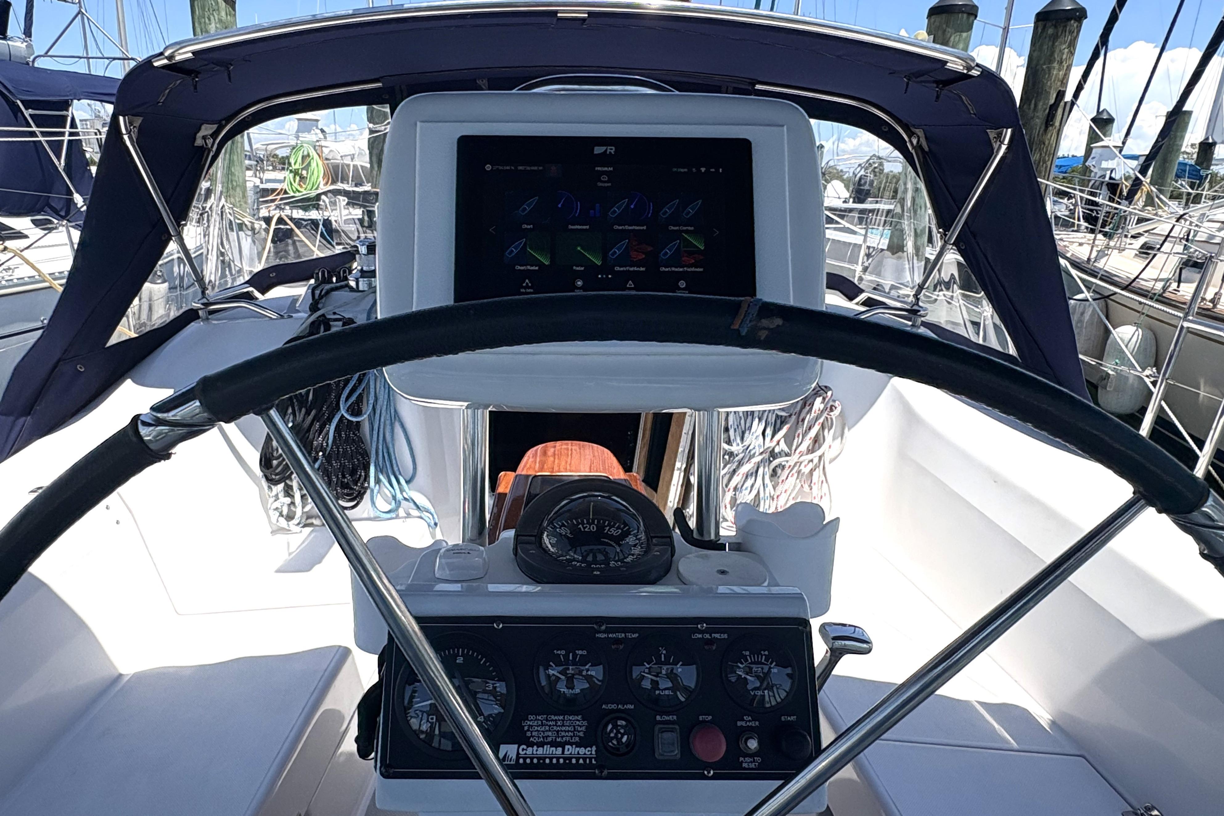 Cockpit view of a 2011 Catalina 355 sailboat with navigation instruments.