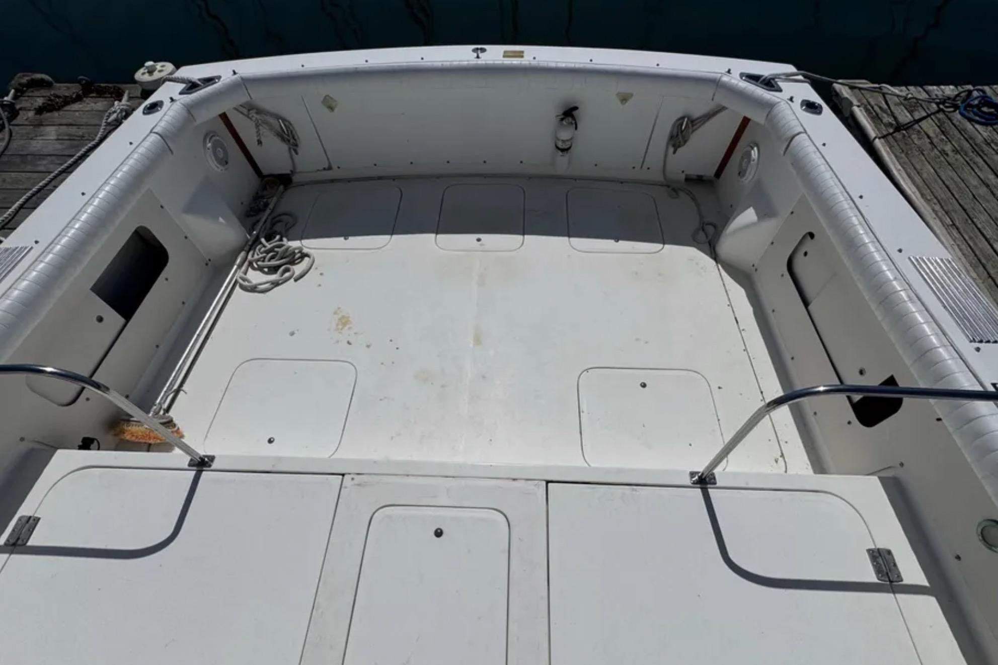 1988 Bertram 28 Sport Fisherman boat deck, spacious and well-maintained, docked at marina.