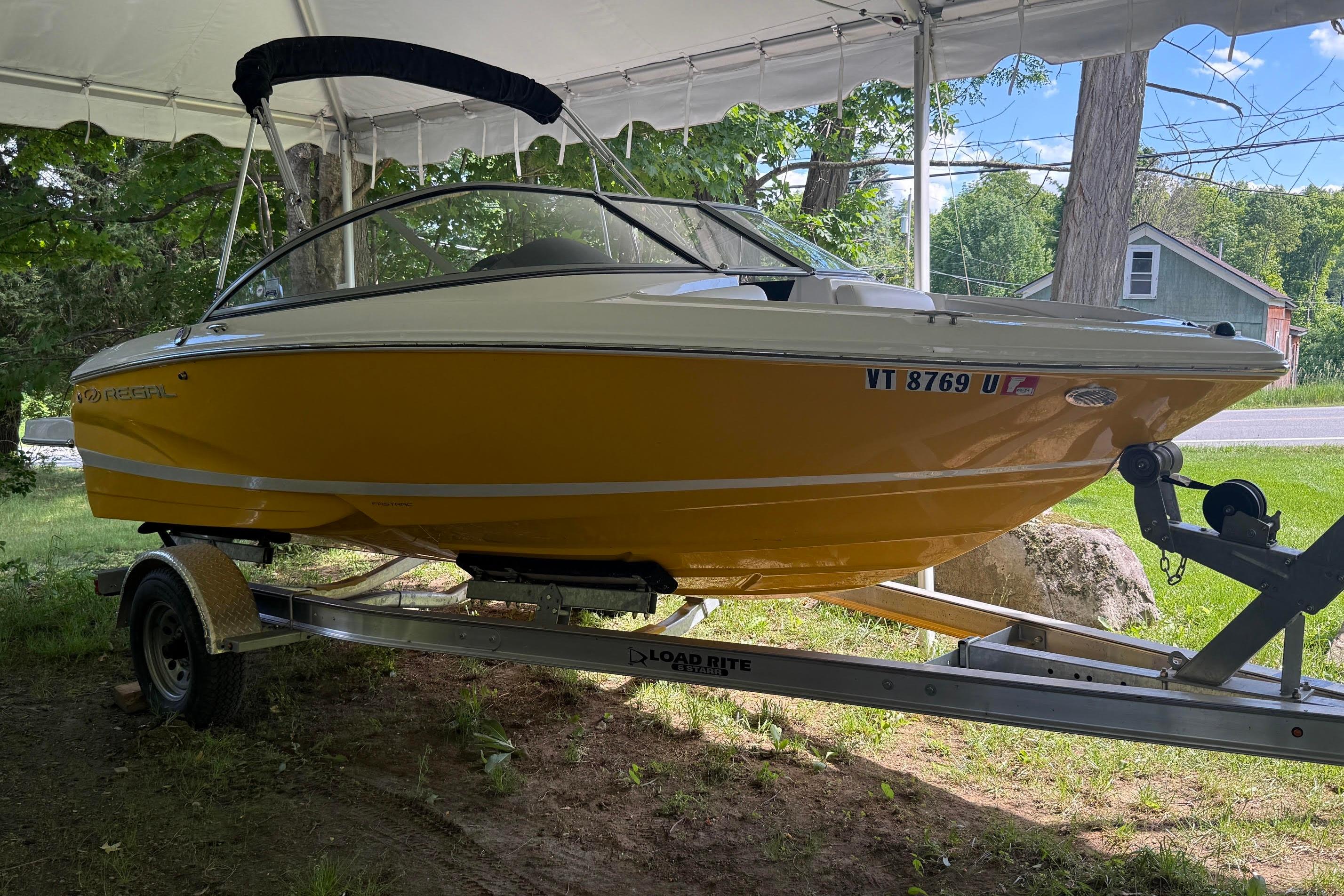 2016 Regal 1900 ES Bowrider boat on trailer under canopy.