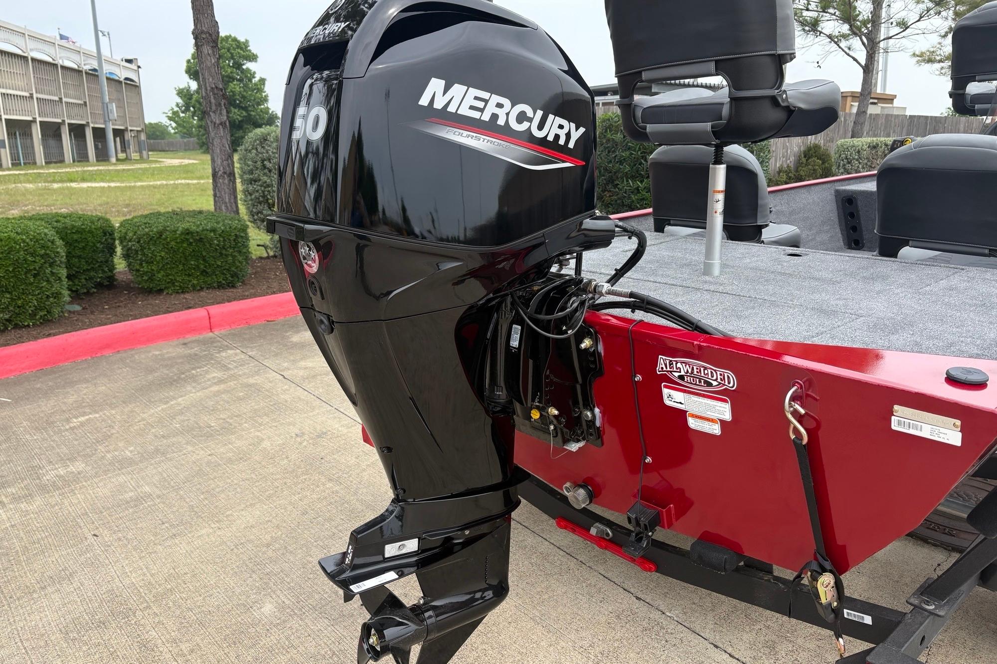 2026 Tracker Bass Tracker Classic XL with Mercury 50 engine, red hull, parked outdoors.